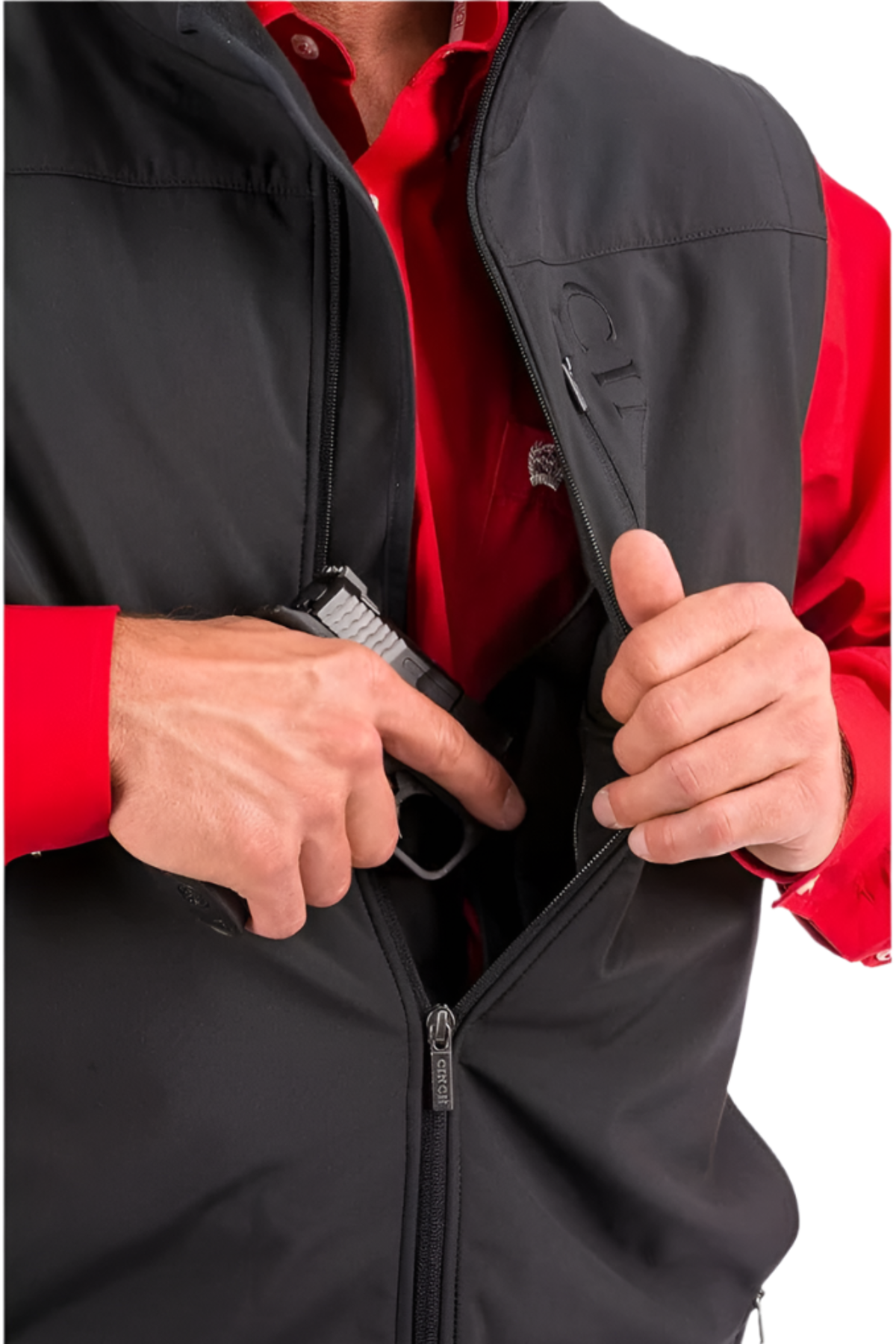 Close-up of concealed carry pocket inside black Cinch vest with firearm partially revealed