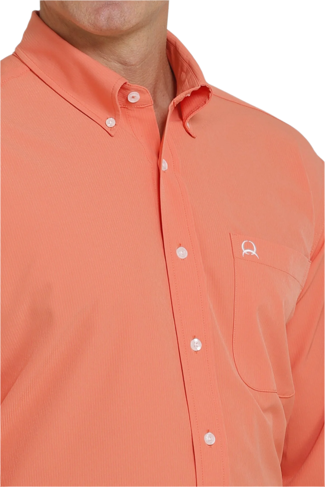 Close-up of a man wearing a coral long-sleeve button-down shirt