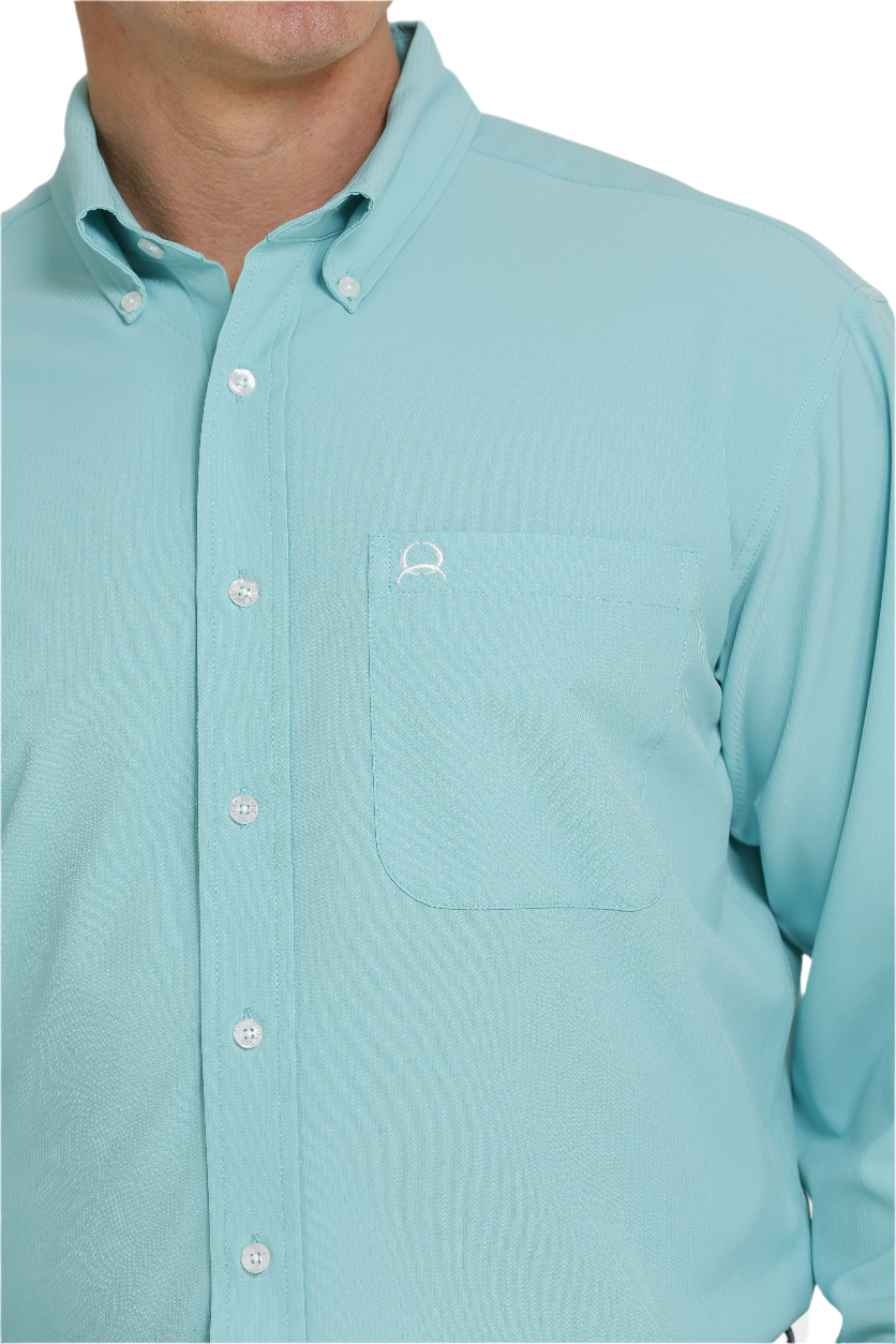 Close-up of a man wearing a long-sleeve turquoise button-down shirt. The shirt has a single chest pocket and white buttons.