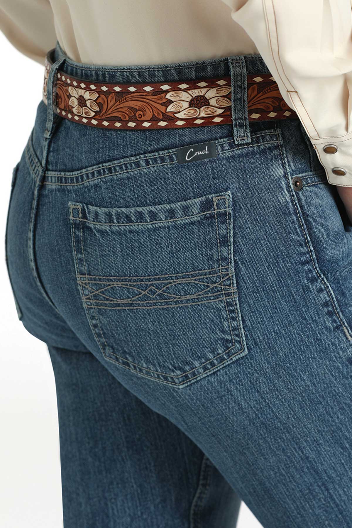 Blue jeans with a decorative belt on a white background