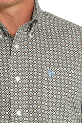 Close-up of a man wearing a patterned gray long sleeve button-down shirt on a transparent background