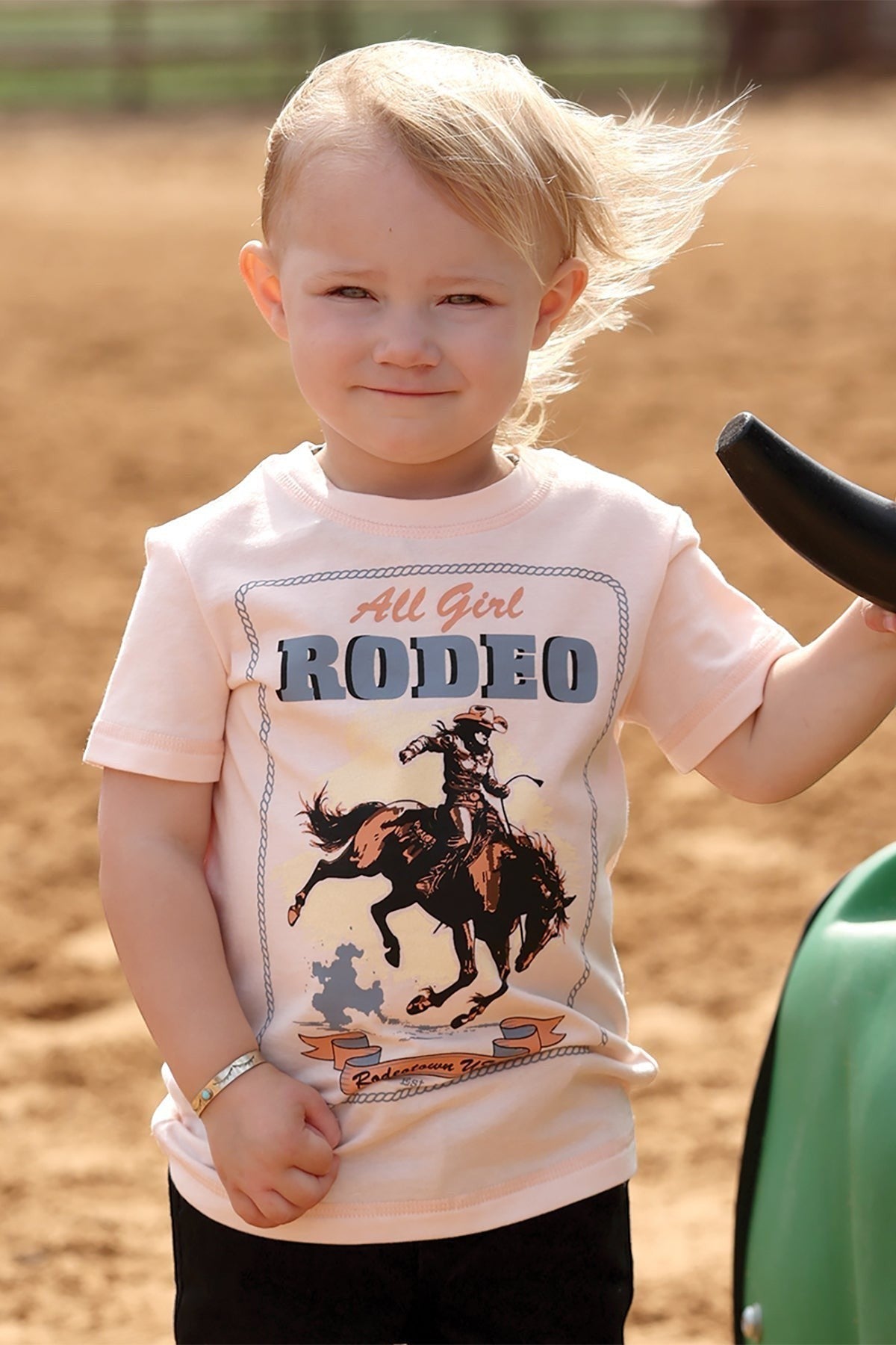 Go West Supply pink toddler cotton tee with "All Girl Rodeo" graphic of a rider on a horse.