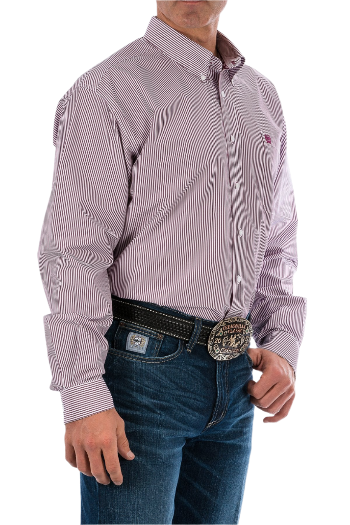 A man wearing a long sleeve striped button-down shirt in burgundy with jeans and a western belt