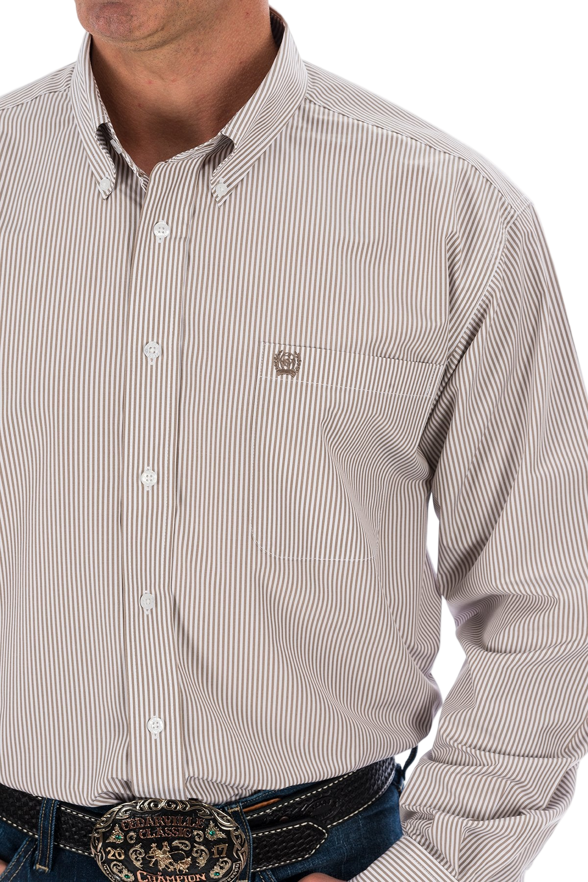 Man wearing a khaki button-up shirt and blue jeans on a white background