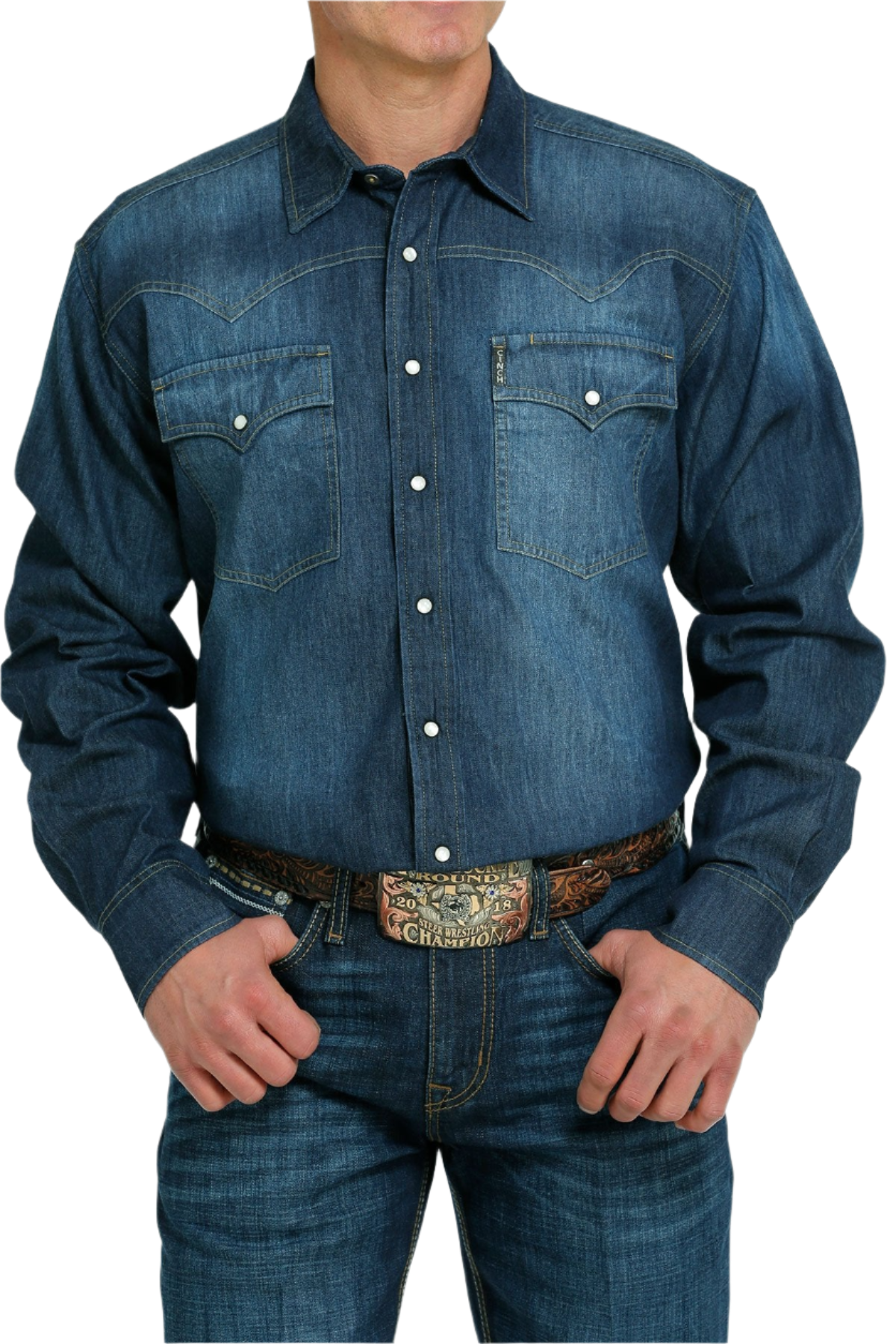A man wearing a long-sleeve denim Western snap shirt with front and back western yokes, and adjustable snap cuffs.