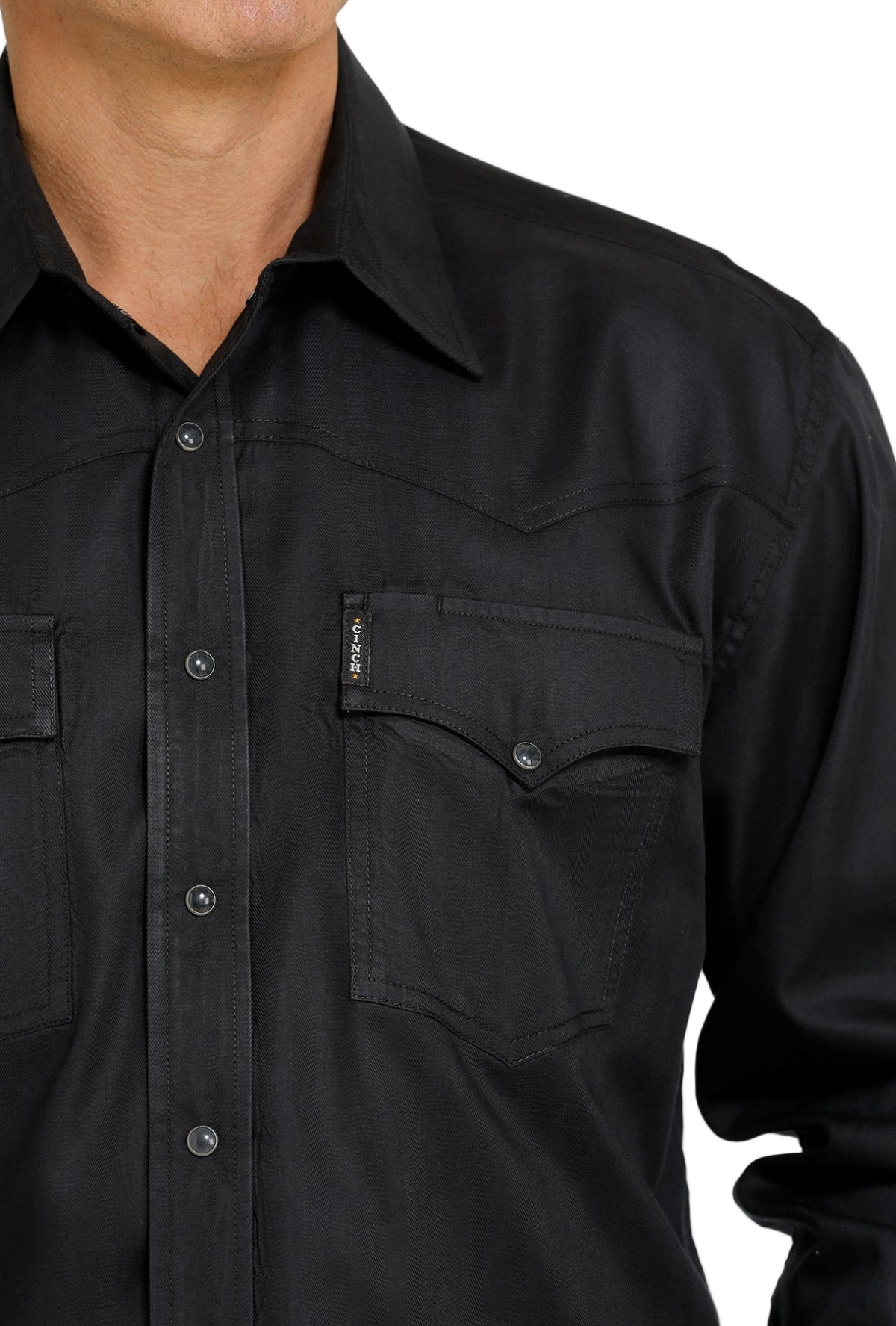 Close-up of a man wearing a black button-up shirt on a white background
