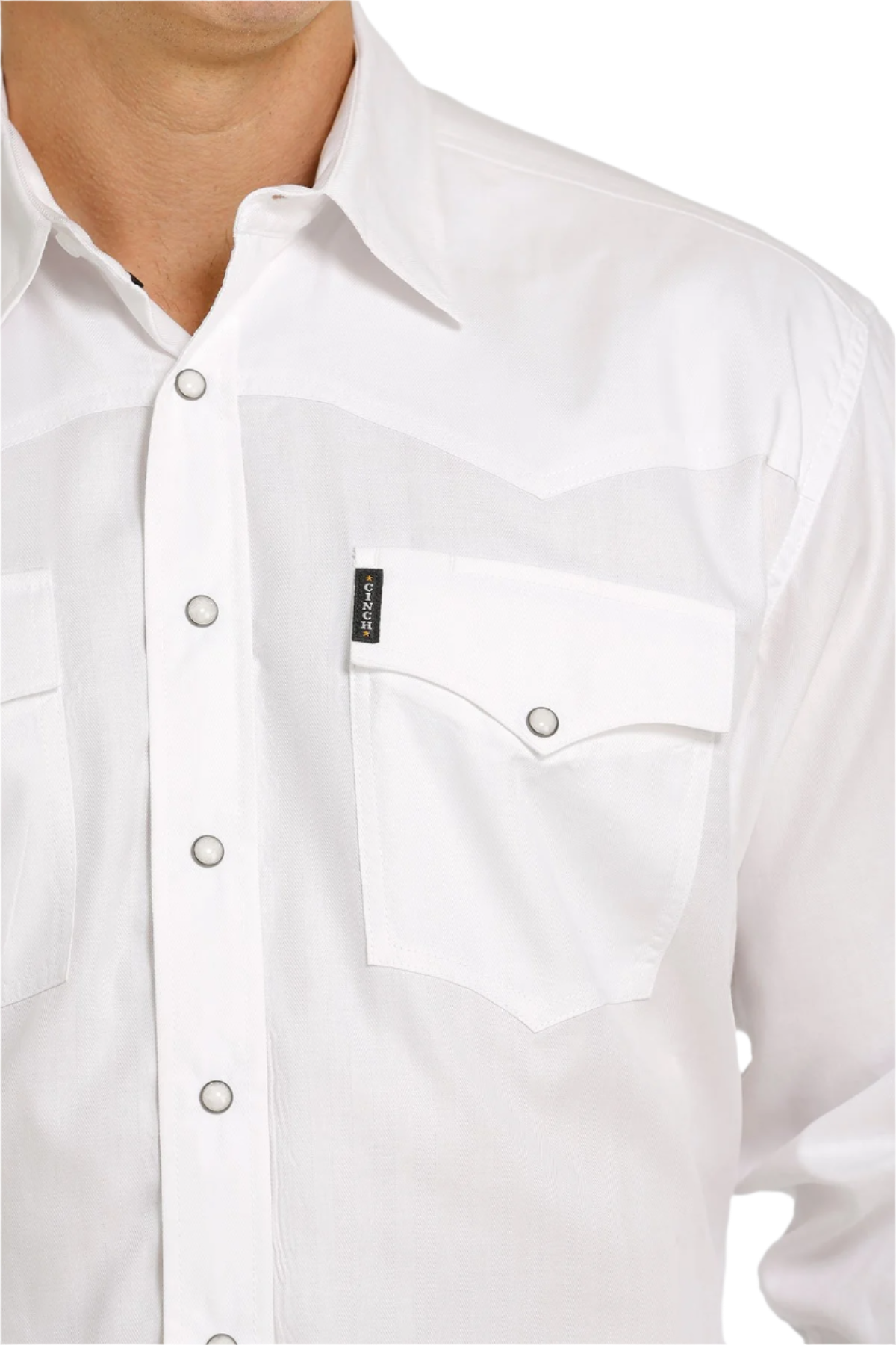 Close-up of a man wearing a long-sleeve white Western snap shirt