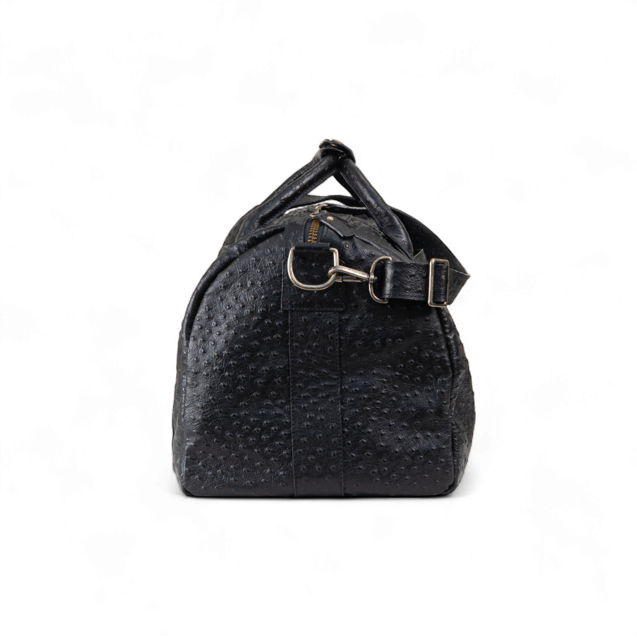 Black duffel bag shown from the side, featuring an ostrich-print texture, gold zipper, and detachable shoulder strap with metal hardware