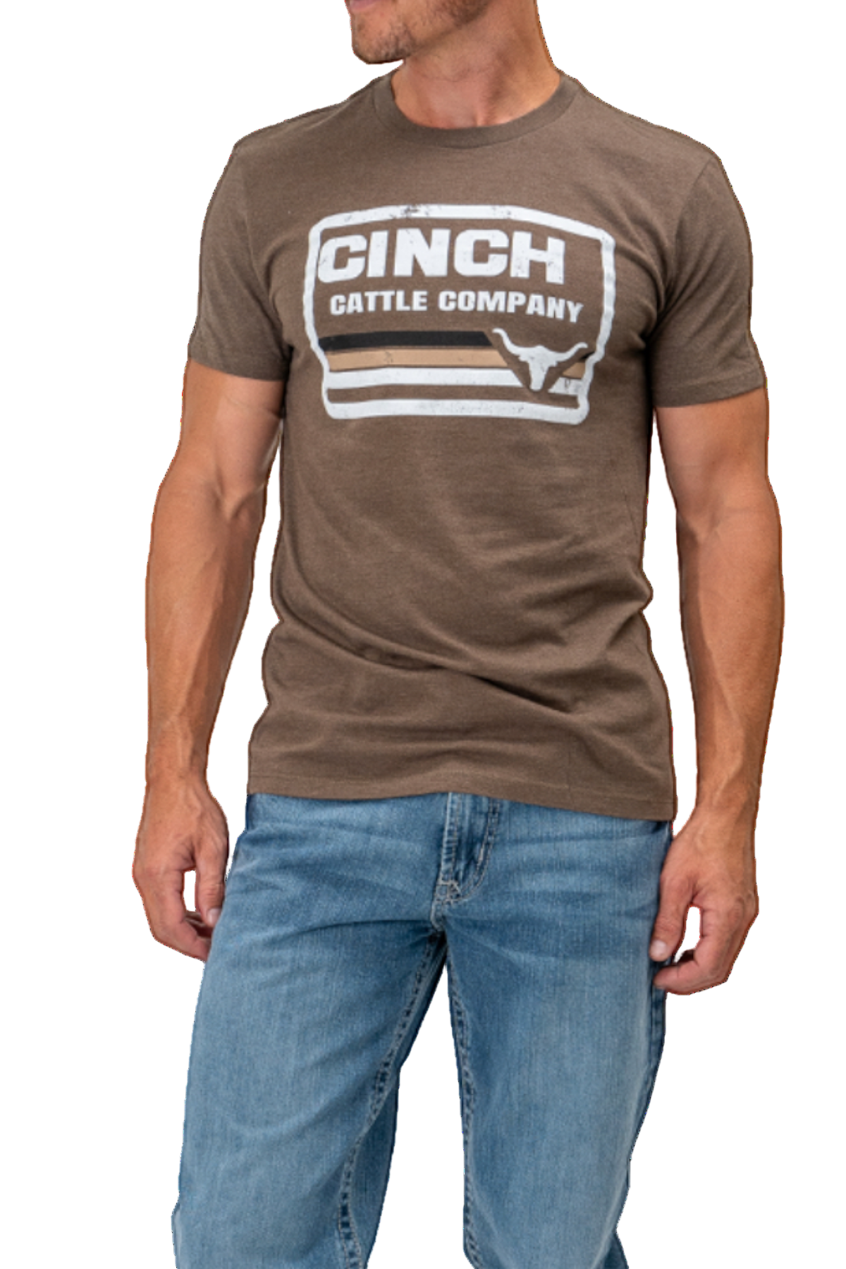 Man wearing a brown Cinch Cattle Company t-shirt and blue jeans on a white background