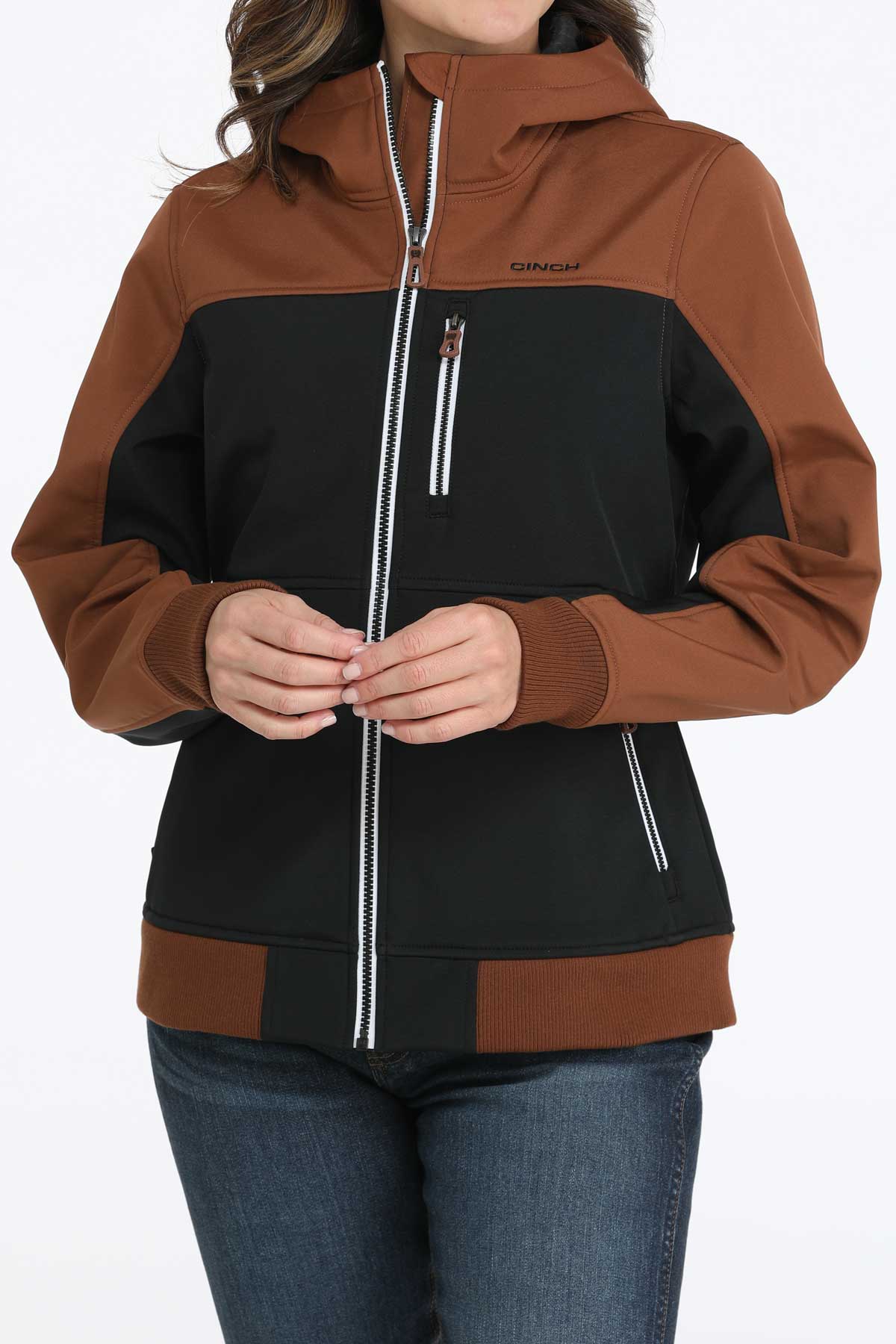 Woman wearing a two-toned black and brown jacket with jeans