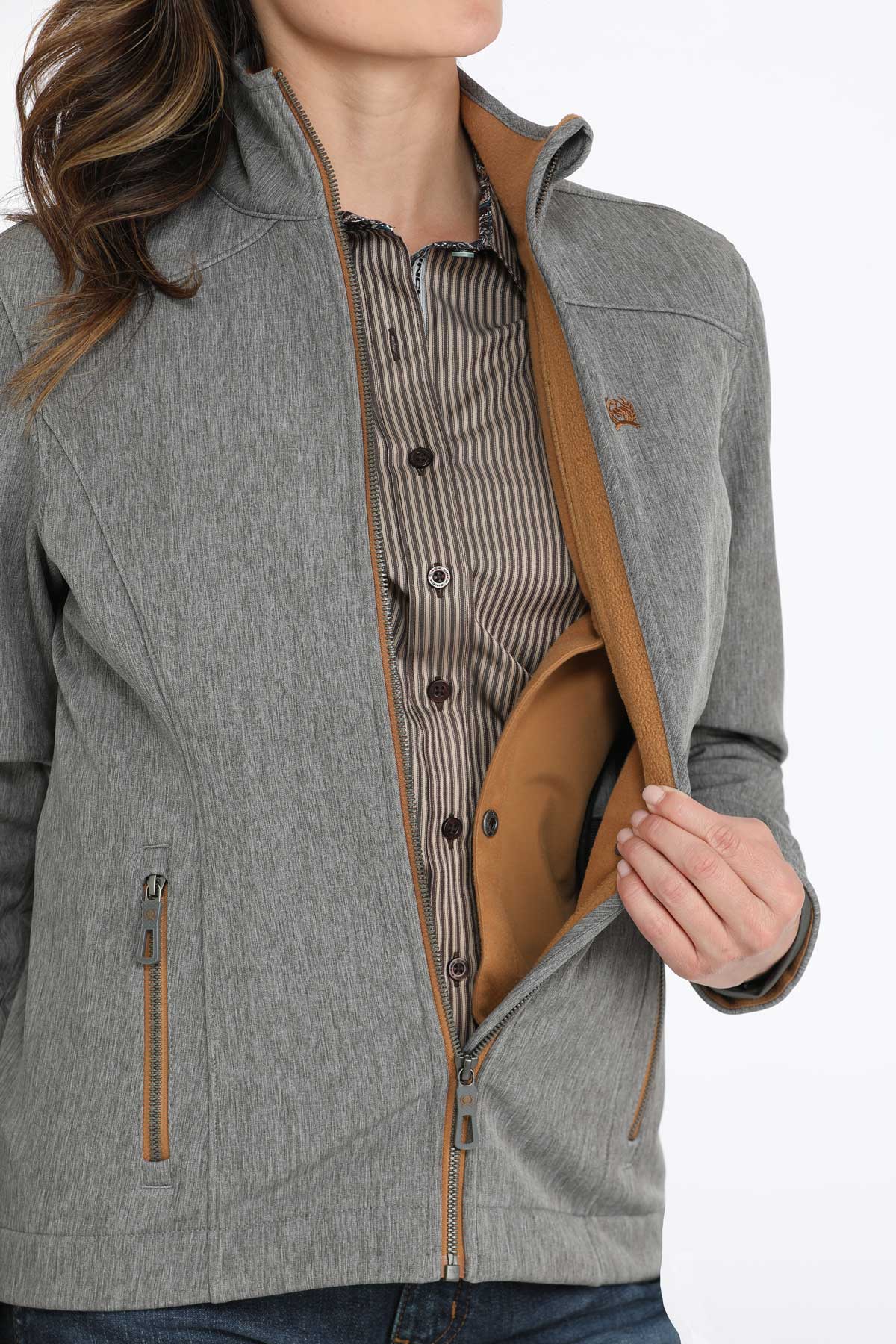 Woman wearing a gray jacket with a concealed carry pocket