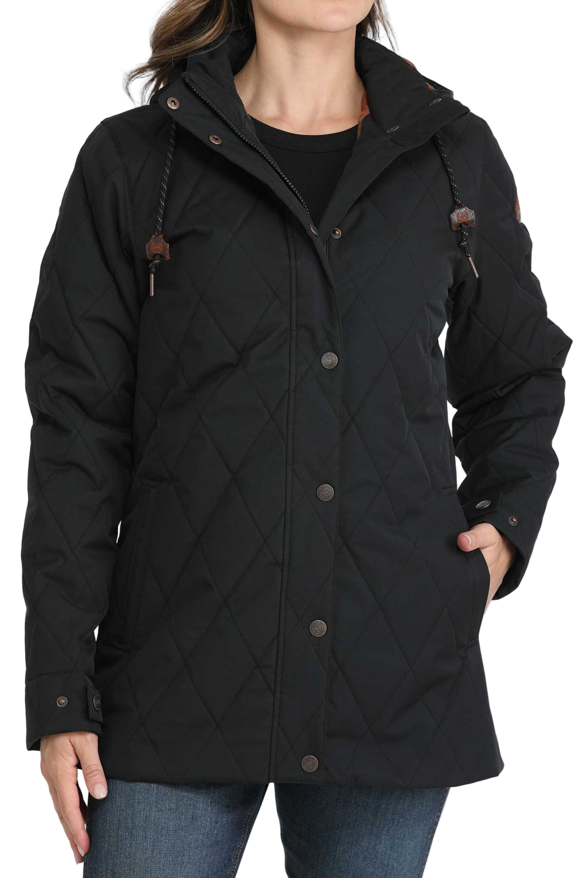 Woman wearing a long black quilted jacket with a hood and jeans