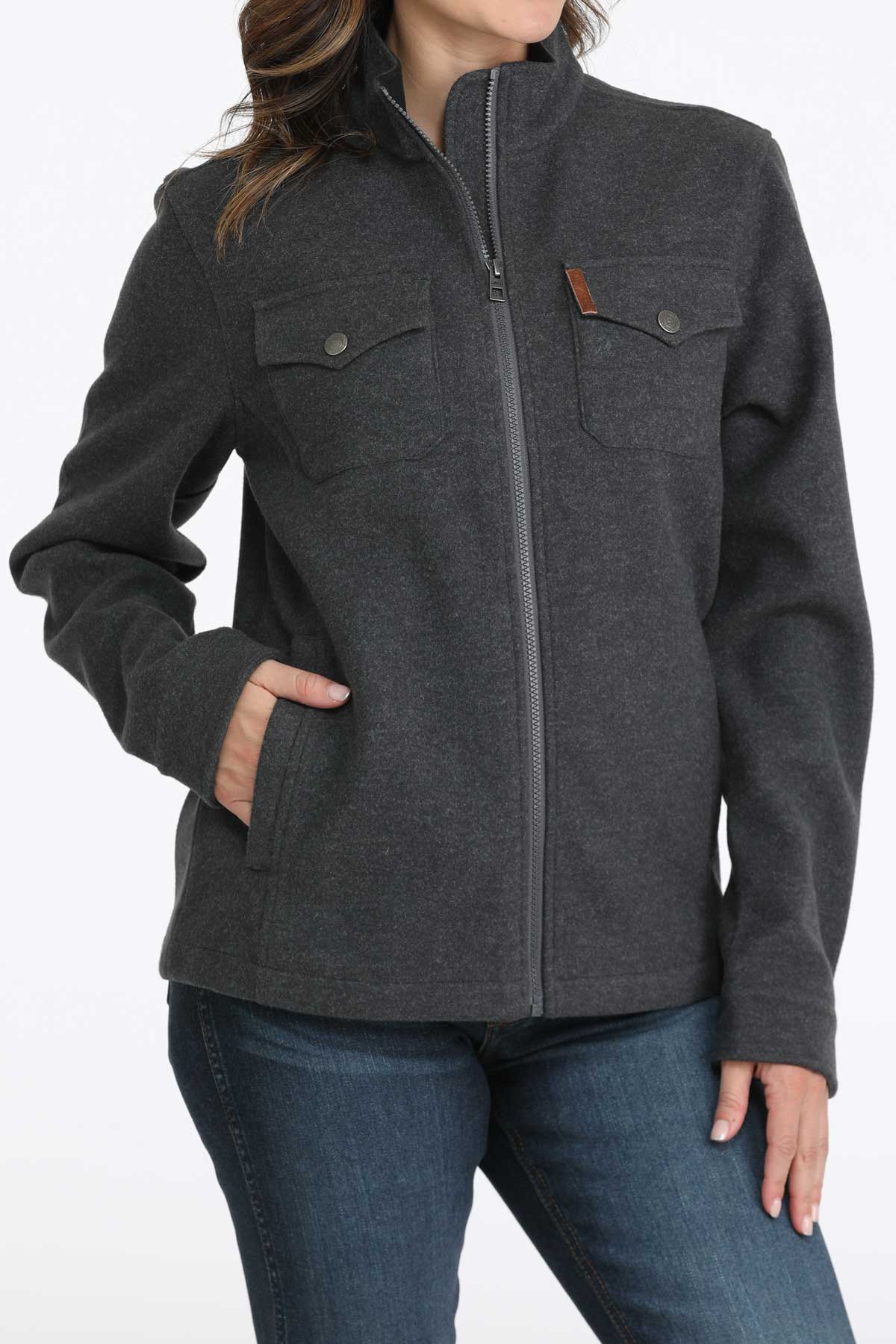 Woman wearing a gray jacket with jeans