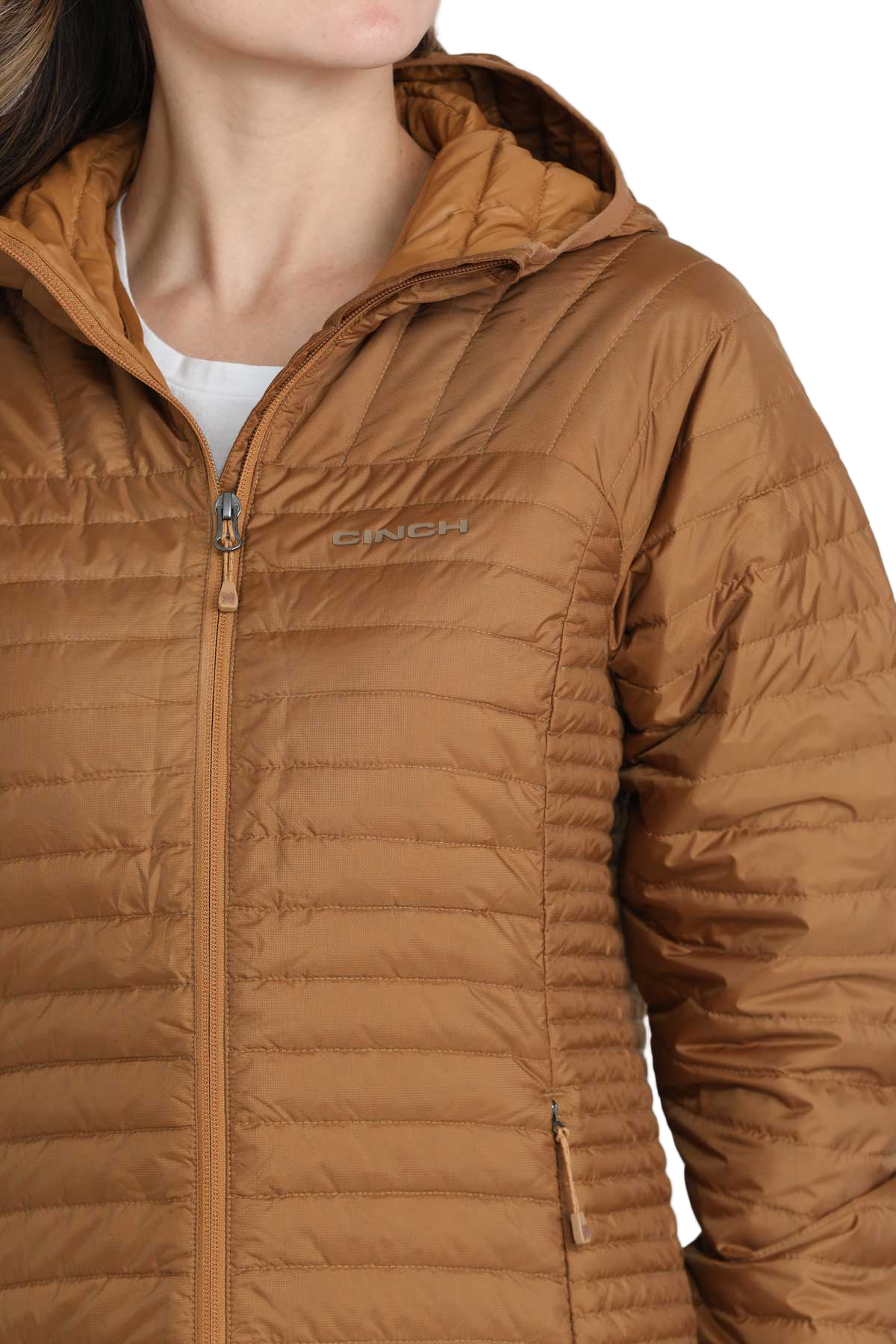 Close-up of a woman wearing a light brown quilted puffer jacket