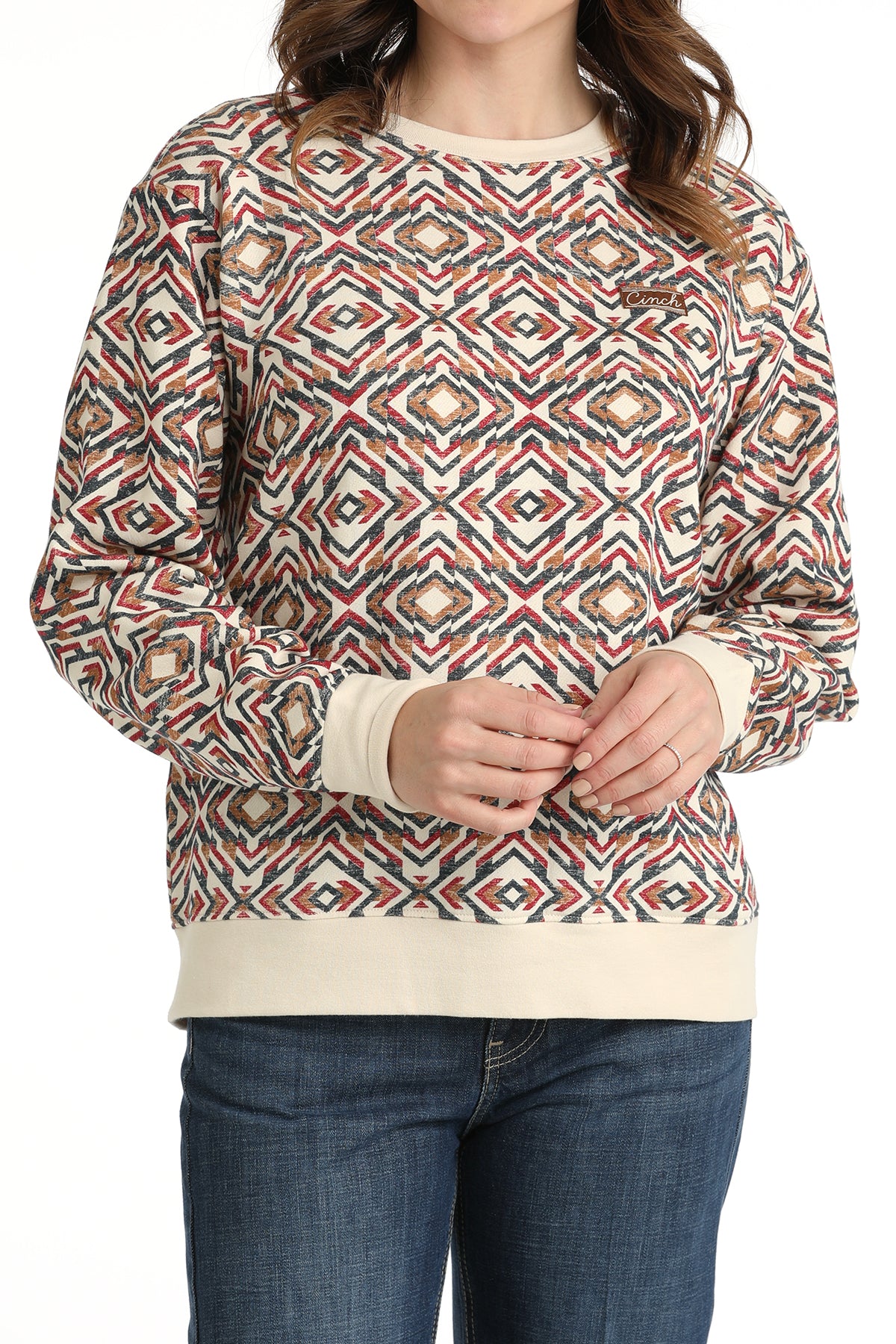 Person wearing a patterned sweater with a plain background