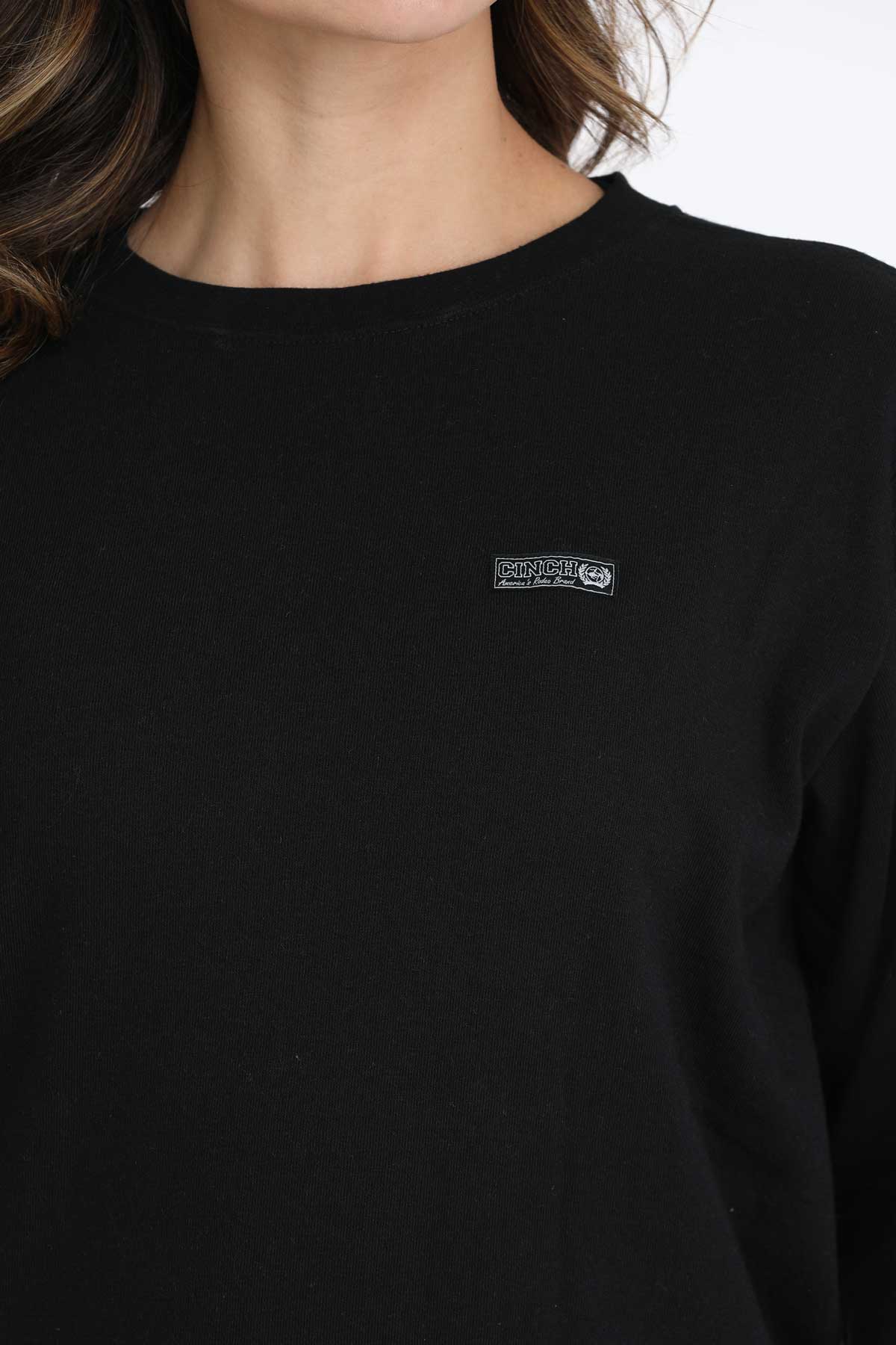 Black long-sleeve shirt with a logo on the chest against a white background