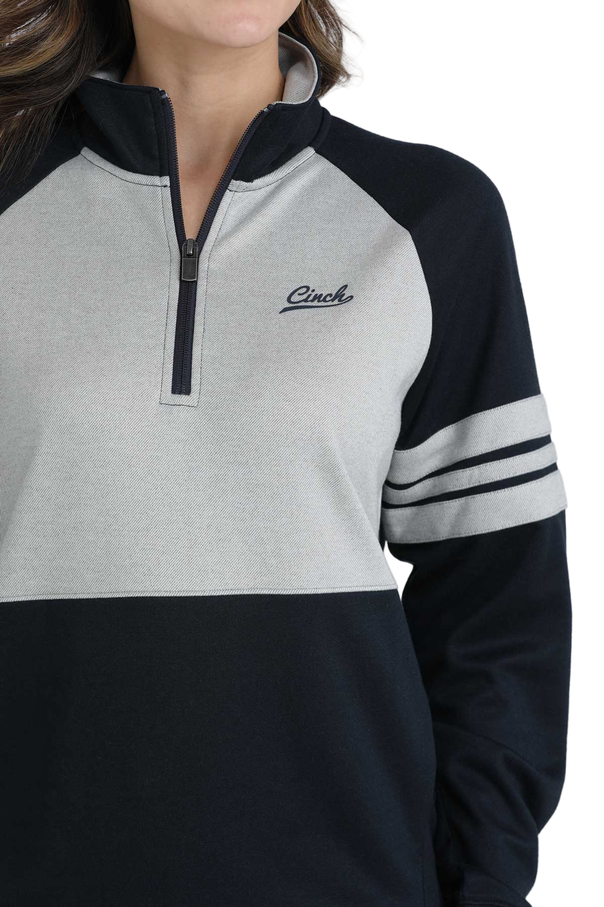 Close-up of a woman wearing a black and heather-gray quarter-zip pullover with striped sleeves