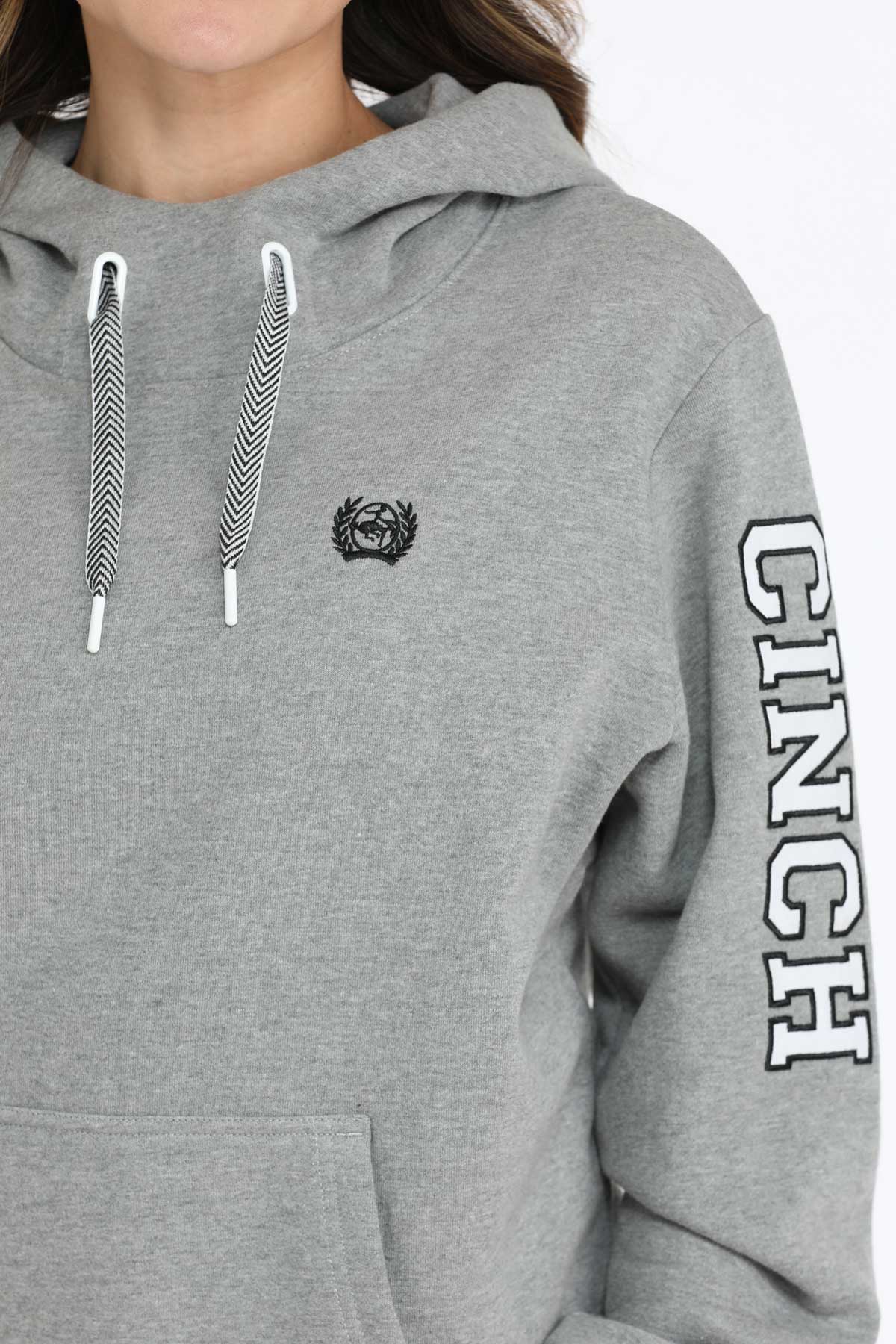 Gray hoodie with brand logo and text on sleeve against a white background