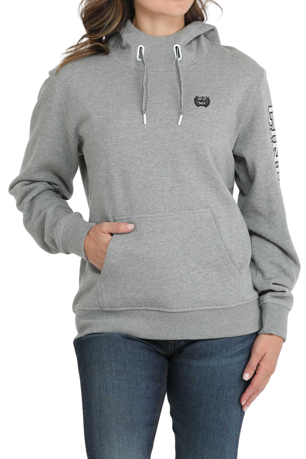 Woman wearing a light-gray hooded sweatshirt with a front pouch pocket and ribbed cuffs, paired with dark-wash jeans
