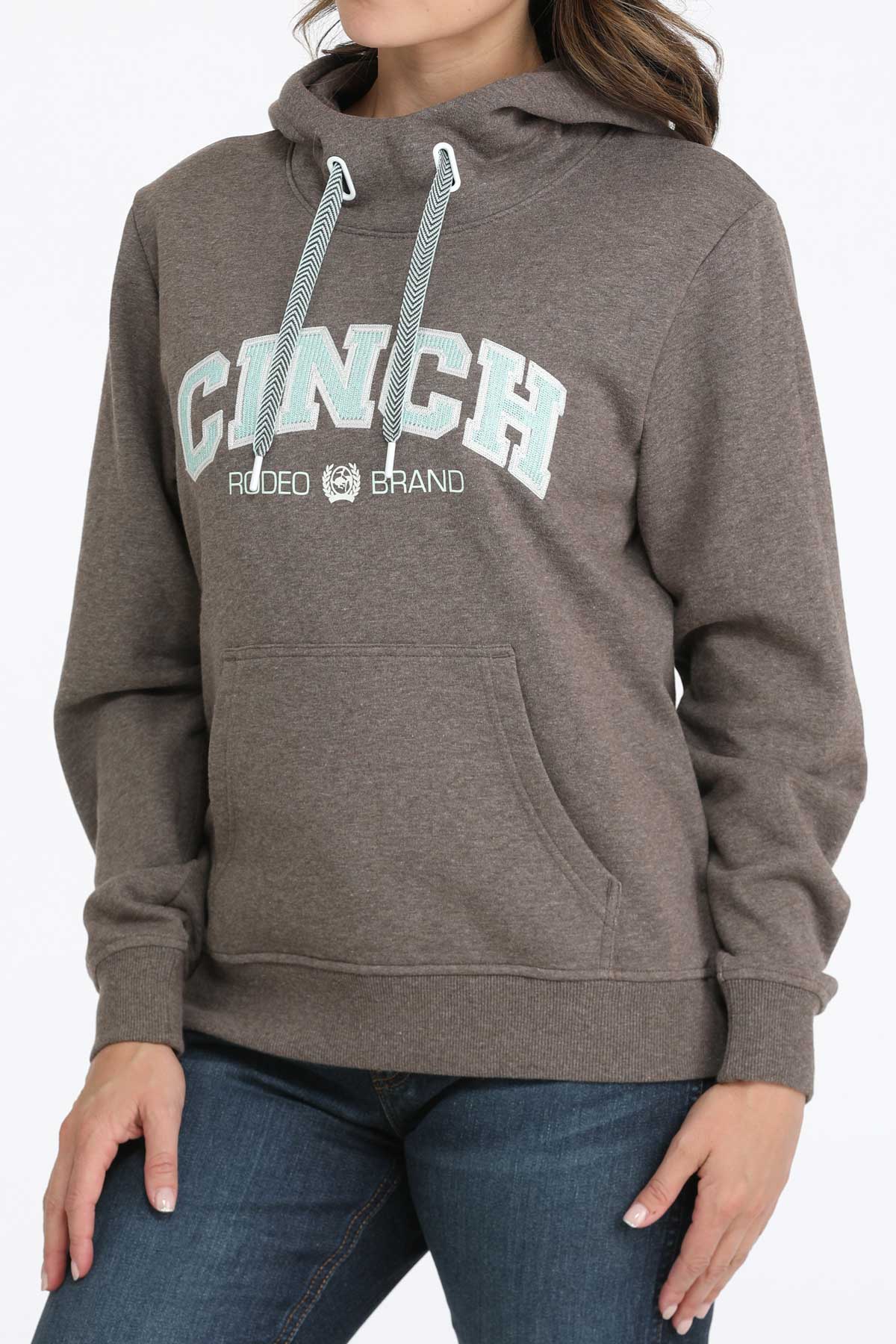 Brown hoodie with 'Cinch' branding worn by a person on a plain background