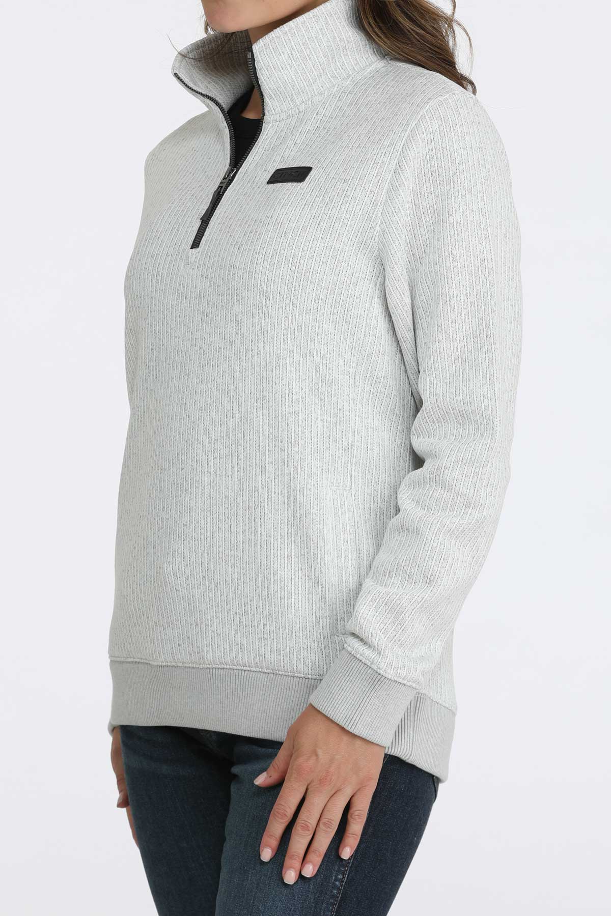 Woman wearing a 1/4 zip pullover with jeans