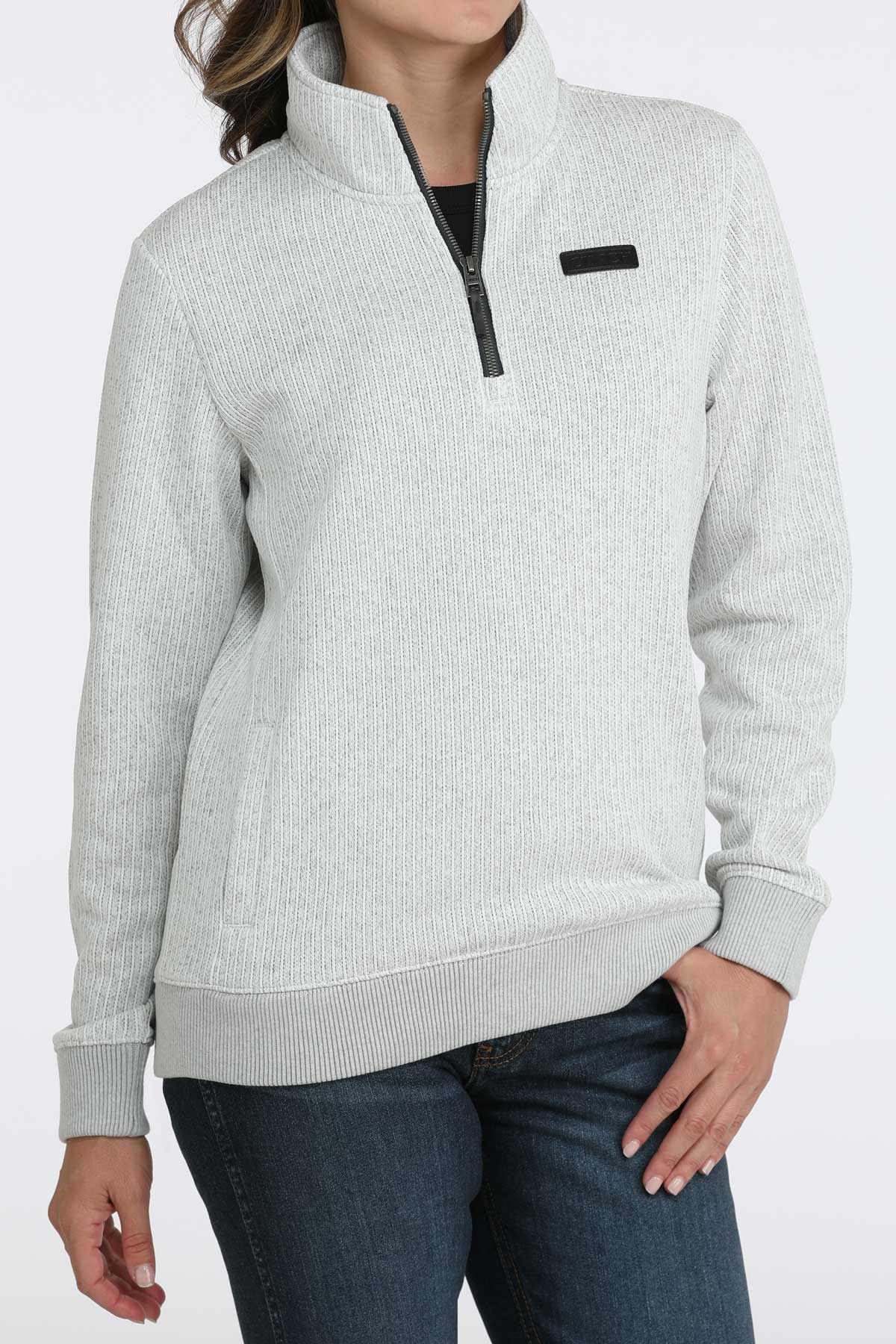 Woman wearing a 1/4 zip pullover with jeans