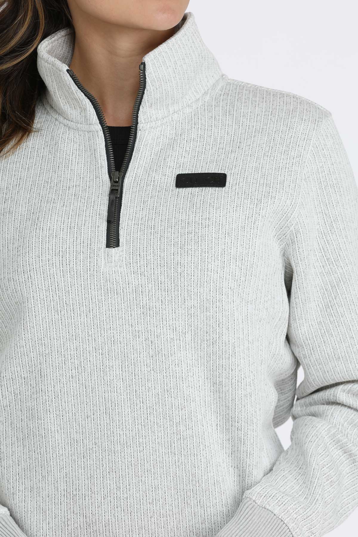 Close-up of a woman wearing a 1/4 zip pullover