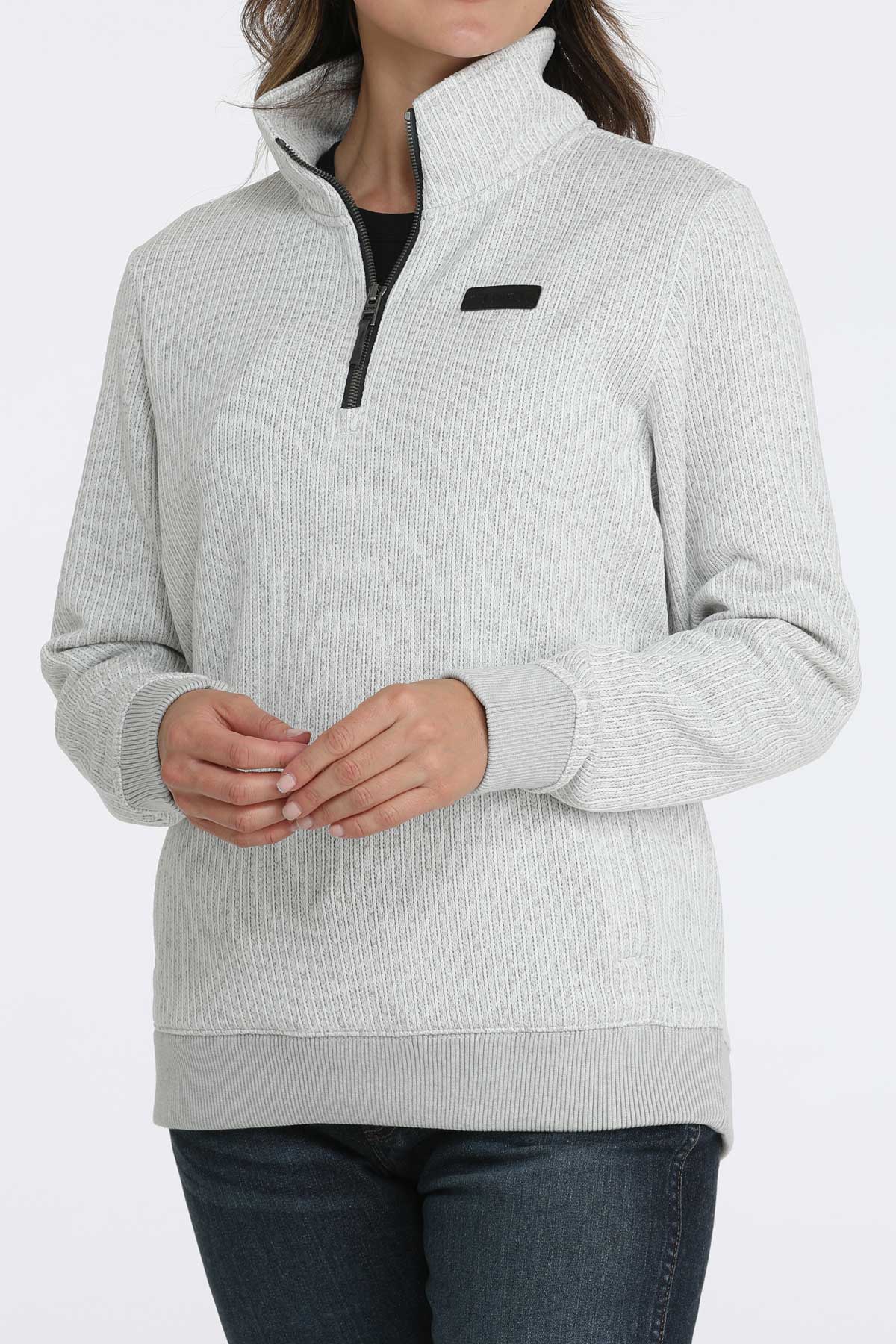 Woman wearing a 1/4 zip pullover with jeans