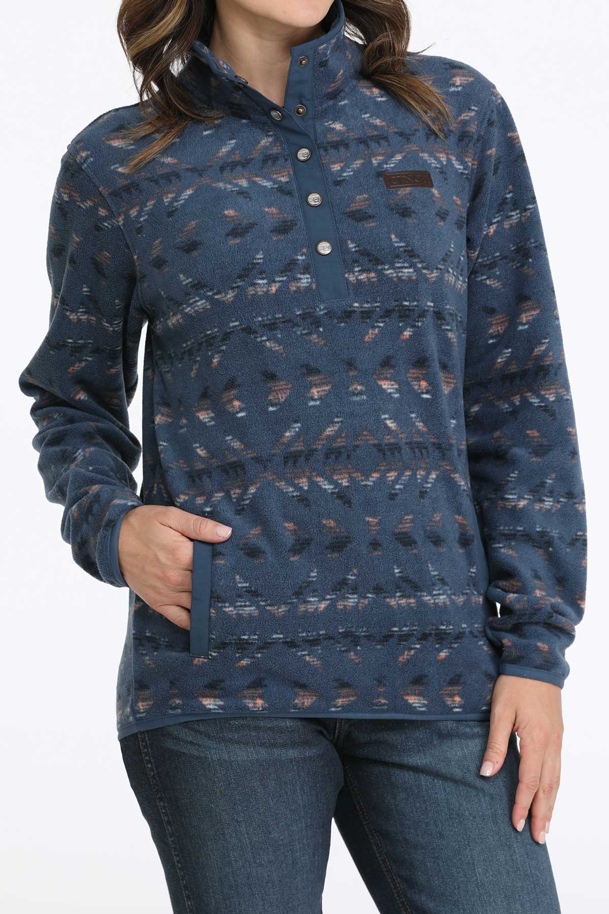 Woman wearing a blue fleece pullover with jeans
