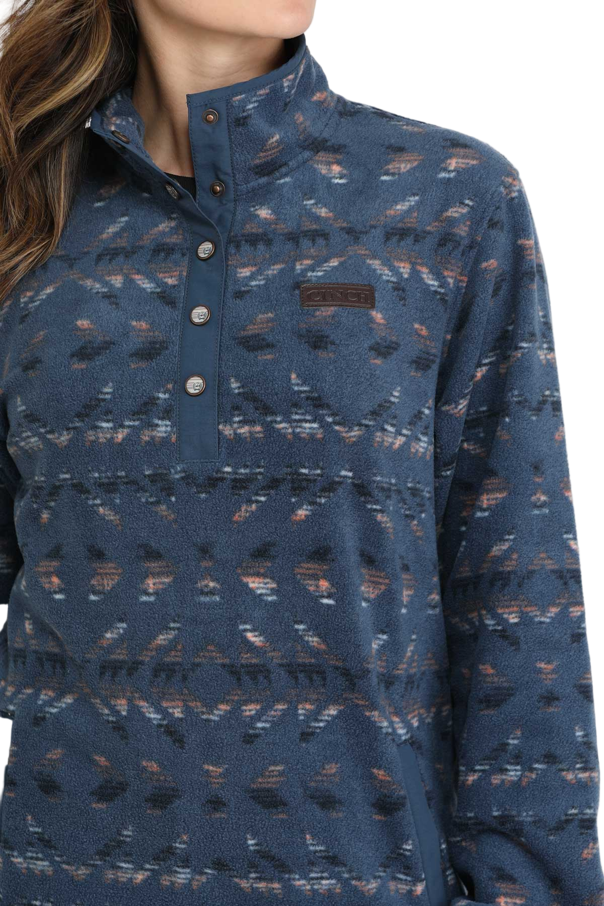 Woman wearing a blue patterned fleece pullover with a snap-up collar and front pocket