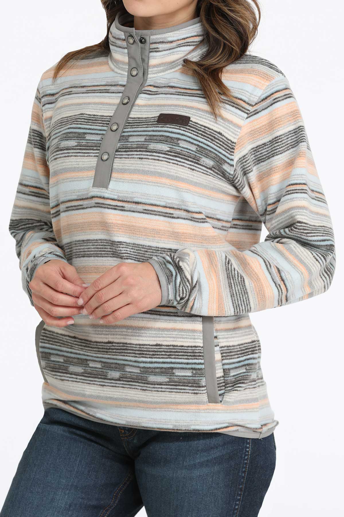 Woman wearing a multi-colored fleece pullover and jeans