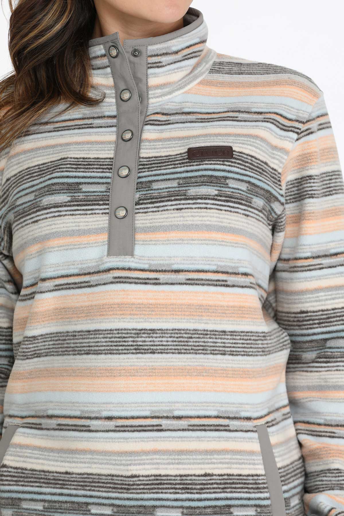 Close-up of a woman wearing a multi-colored fleece pullover