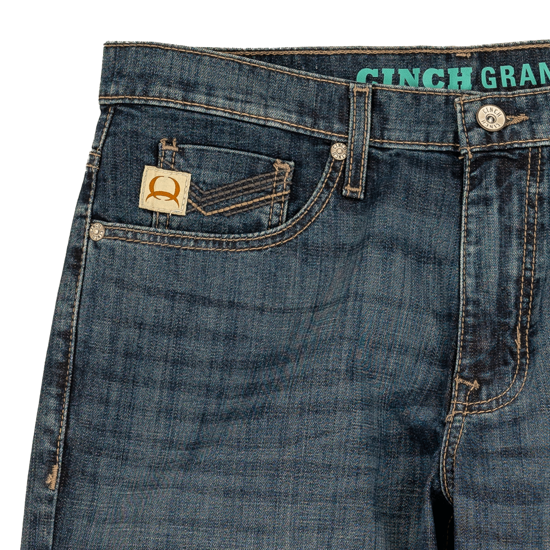 Close-up of the top front section of dark wash denim jeans featuring a coin pocket with a stitched logo patch, metal rivets, belt loops, and a visible waistband with the text 'CINCH' in turquoise