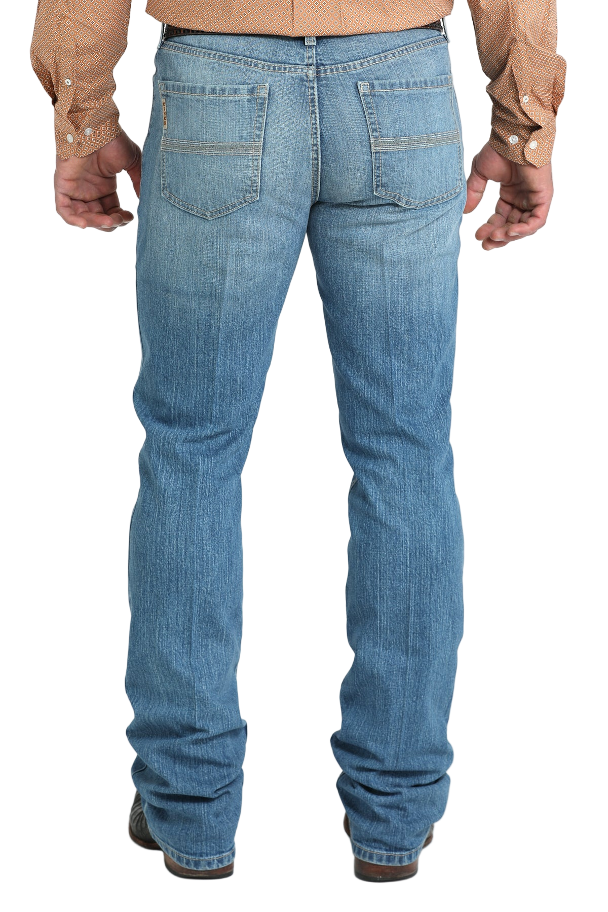 Back view of a man wearing blue denim jeans, and a belt, with a tucked-in patterned shirt