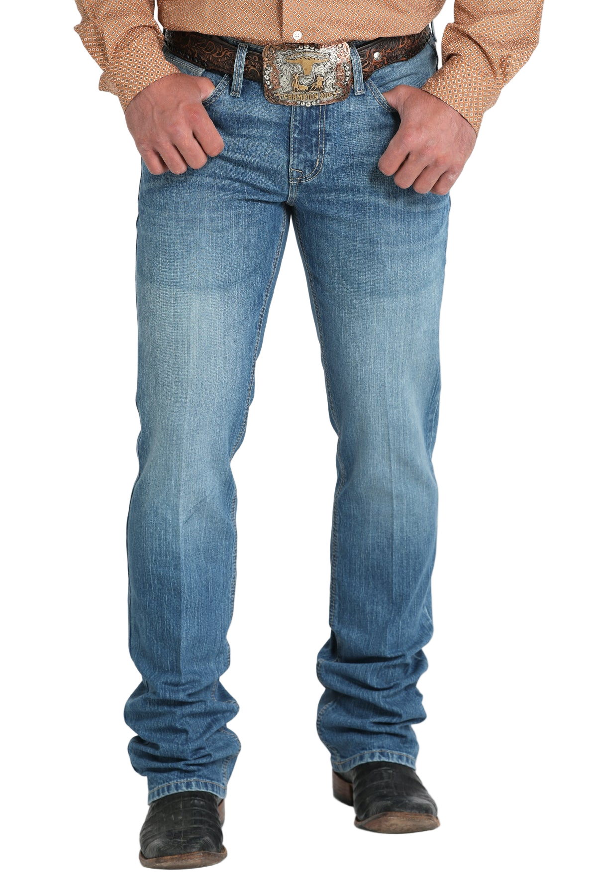 Front view of a man wearing blue denim jeans, a belt, a tucked-in patterned shirt and boots