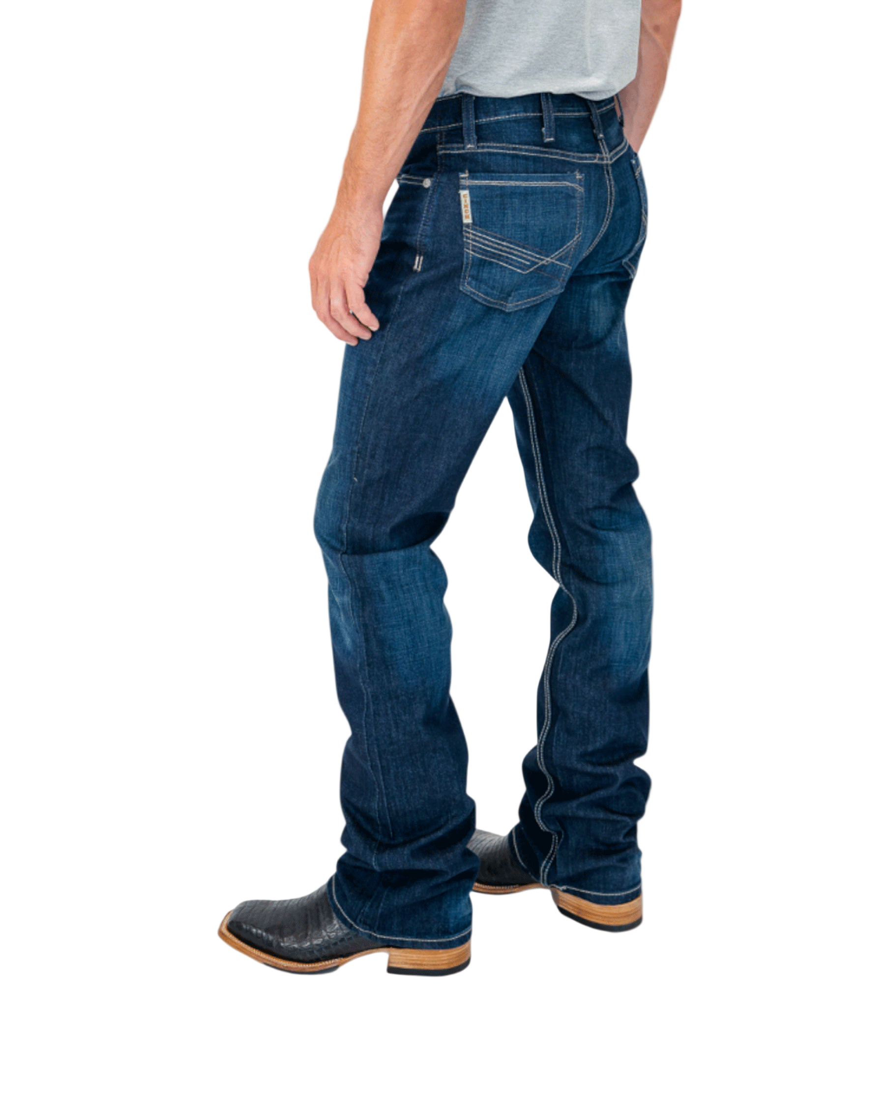 Person wearing blue jeans and black boots on a white background