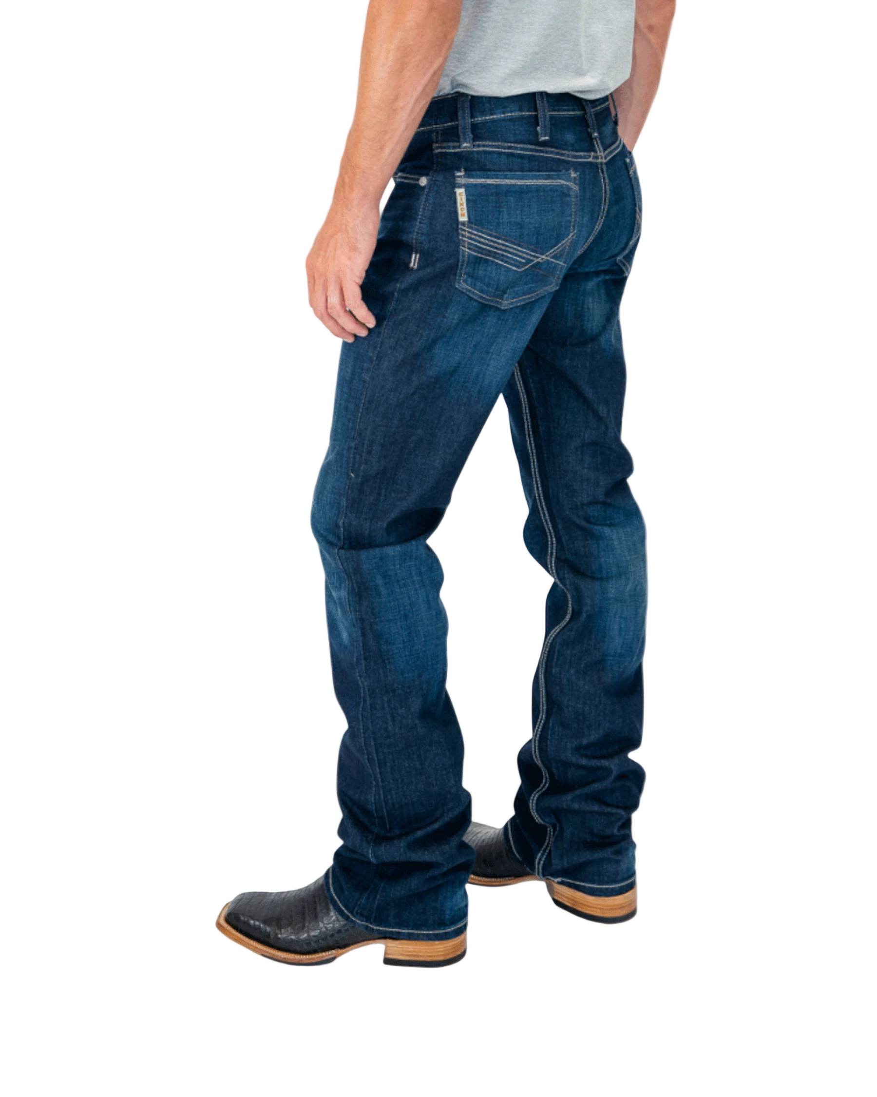 Person wearing blue jeans and black boots on a white background