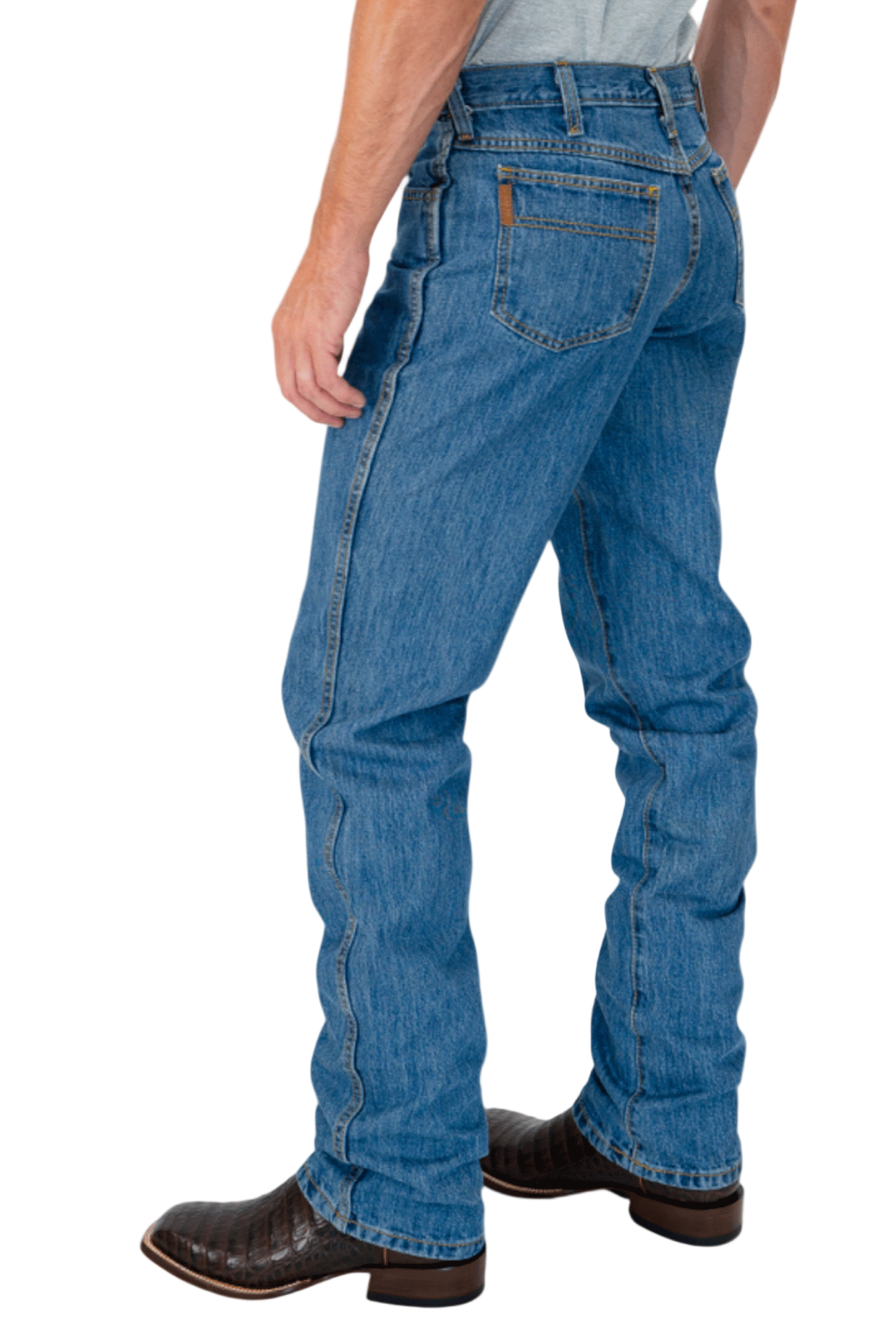 Person wearing blue jeans and brown boots on a white background