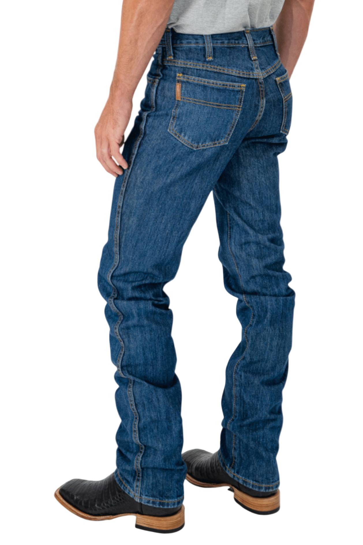 Person wearing blue jeans and black boots on a white background