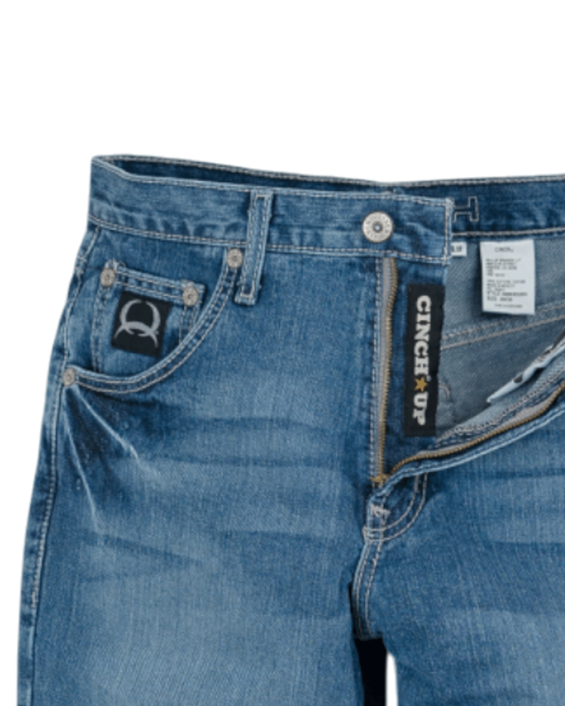 Close-up of blue jeans with a visible brand label on a white background