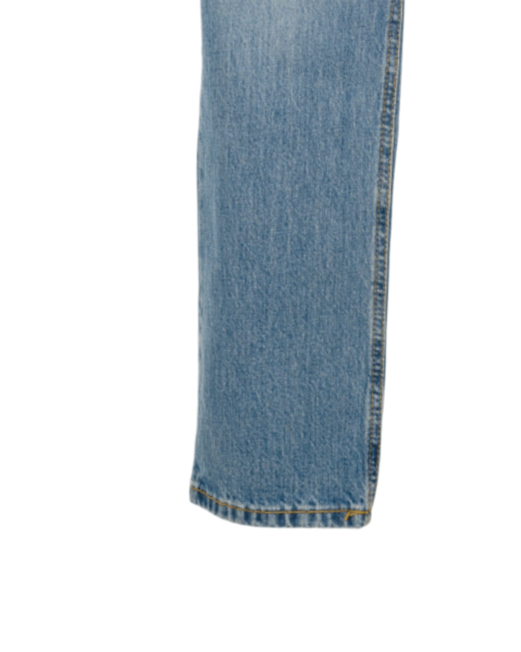 Close-up of blue denim jeans on a white background