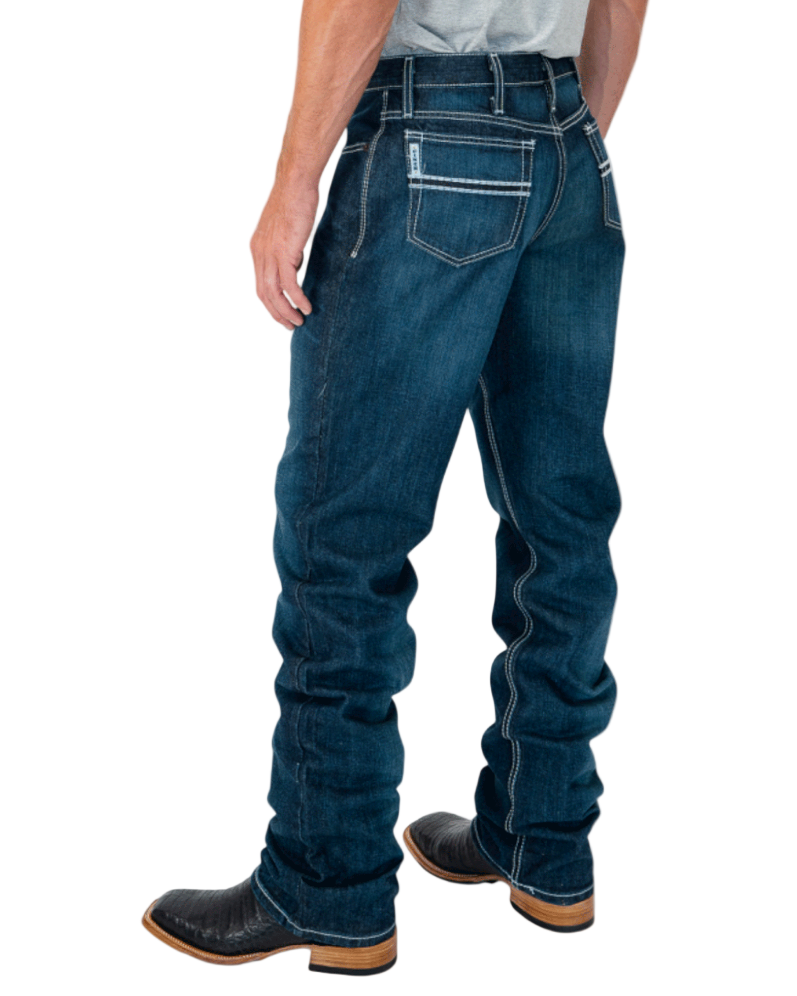 Person wearing blue jeans and black boots on a white background