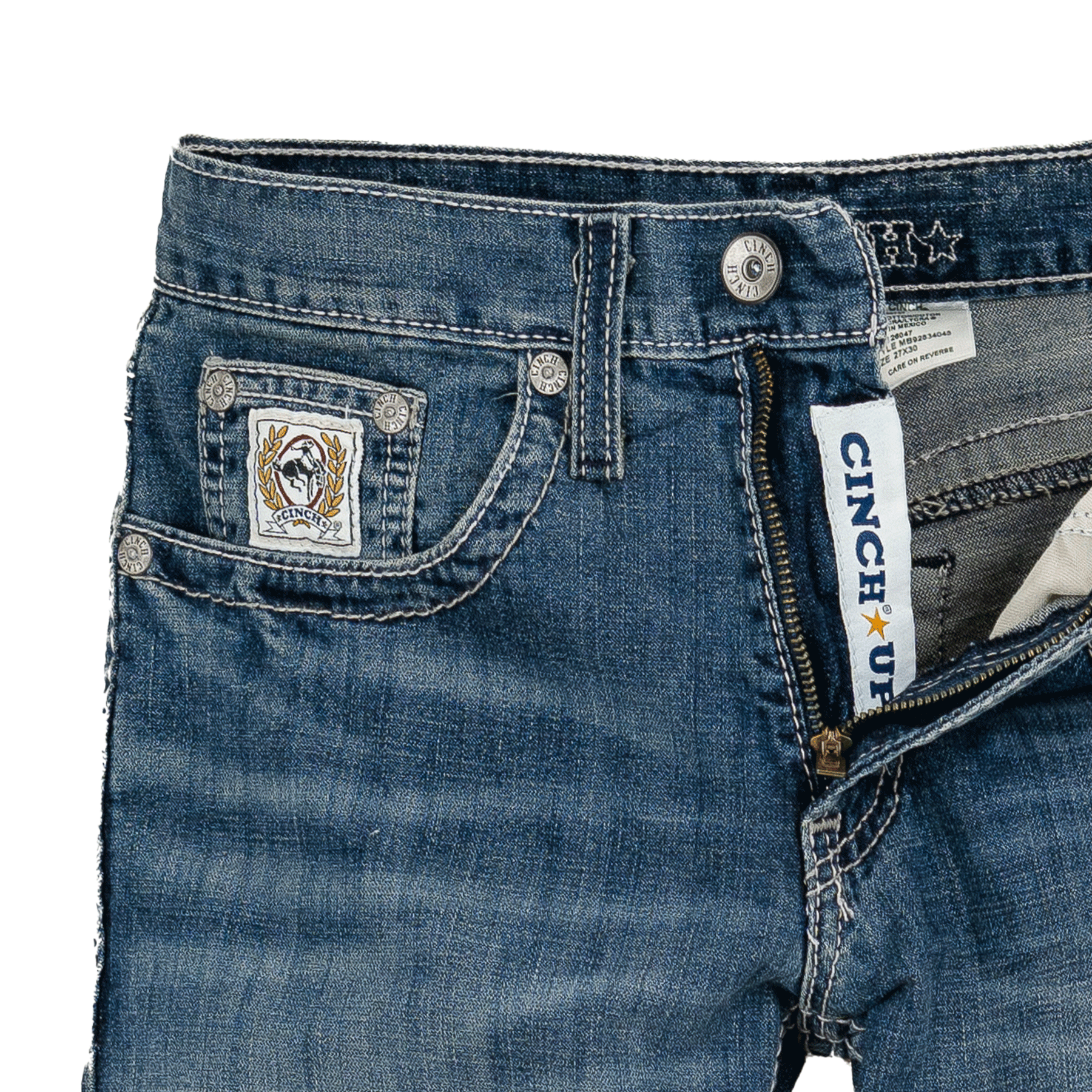 Close-up of blue jeans with a brand label on a white background