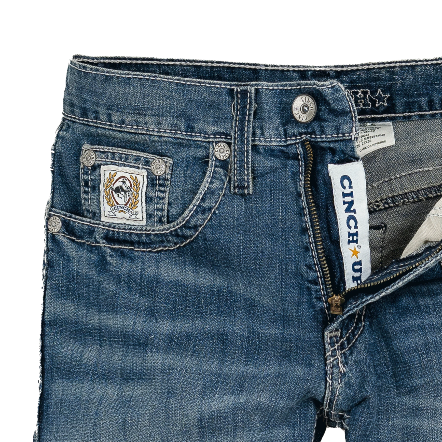 Close-up of blue jeans with a brand label on a white background