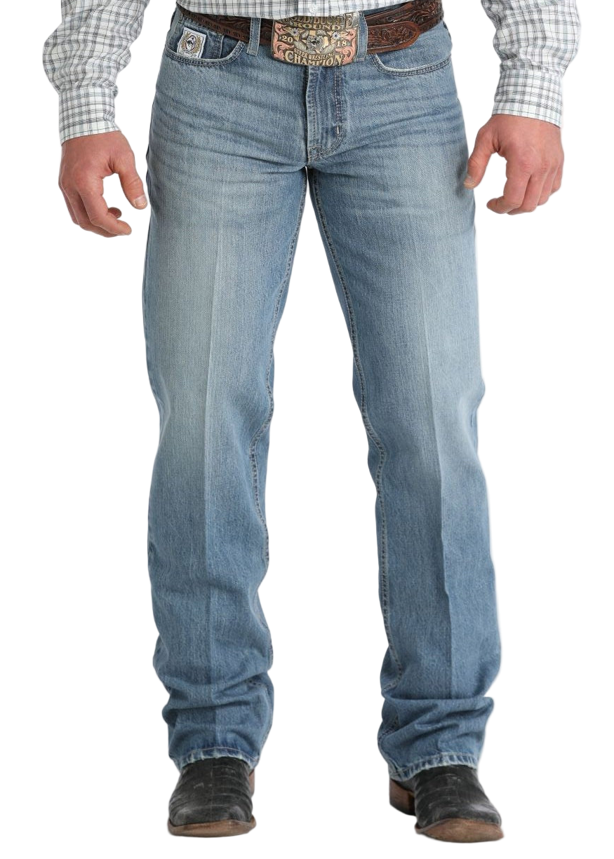 Front view of a man wearing light-wash blue jeans with a straight-leg fit. He has on a patterned belt with a large buckle, and his shirt is tucked in