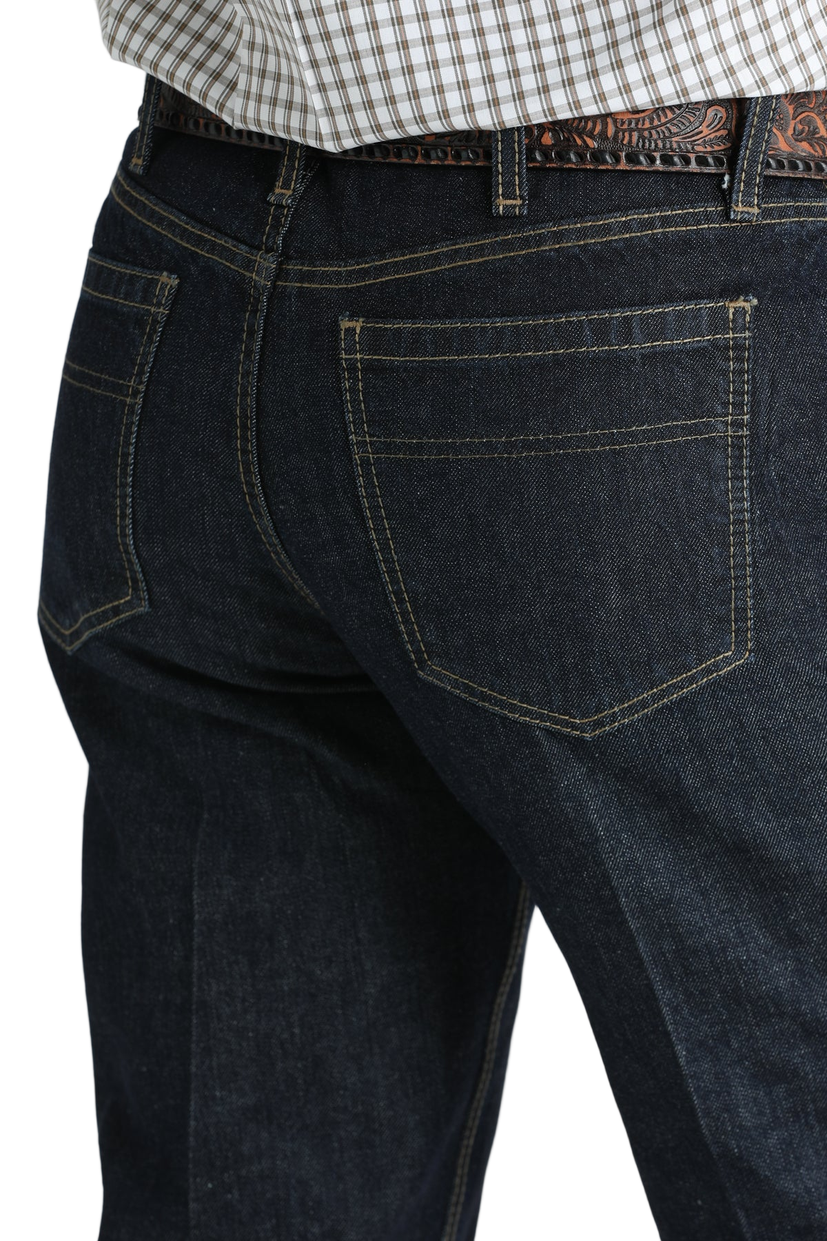 Close-up, back view of a man wearing dark blue denim jeans, and a belt, with a tucked-in patterned shirt