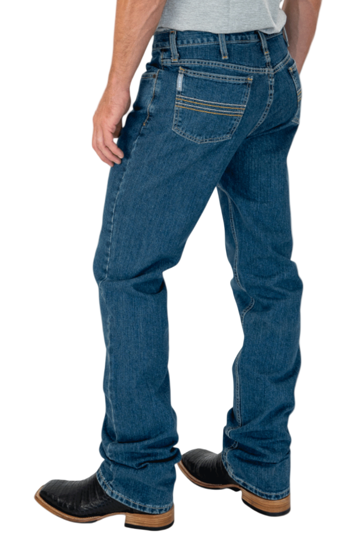 Person wearing blue jeans and black boots on a white background