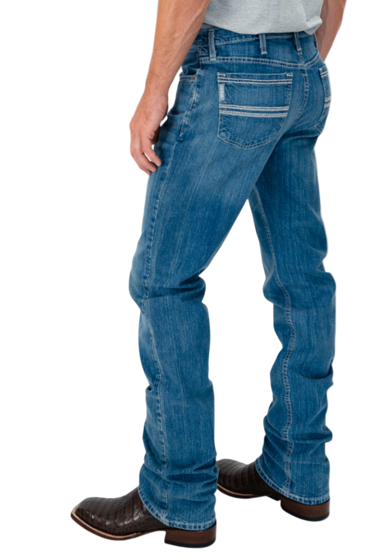 Person wearing blue jeans and brown boots on a white background