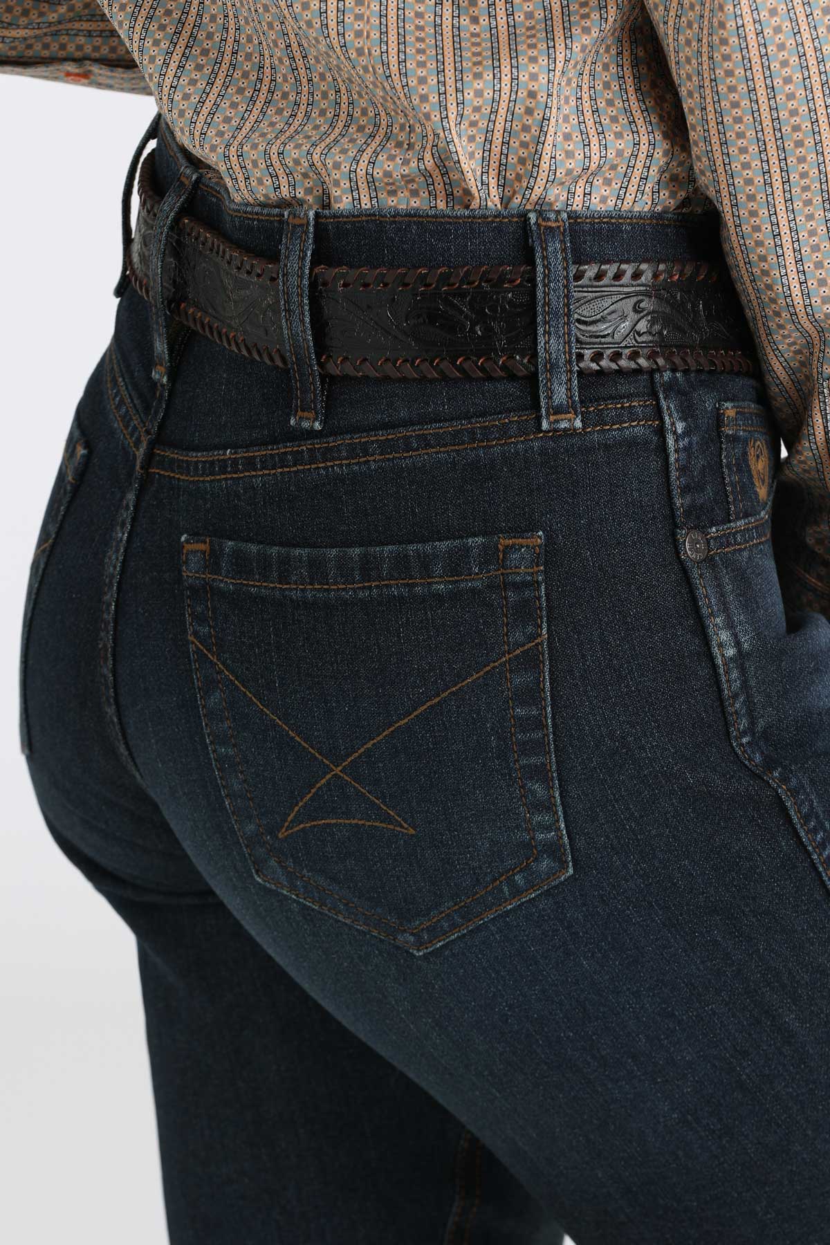 Side view close-up of Cinch ladies’ dark wash boot cut jeans highlighting pocket stitching