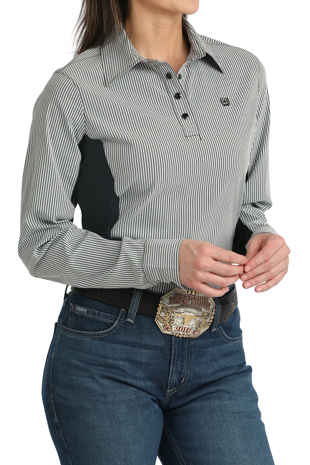 Person wearing a gray and white striped shirt with a black patch, blue jeans, and a decorative belt.